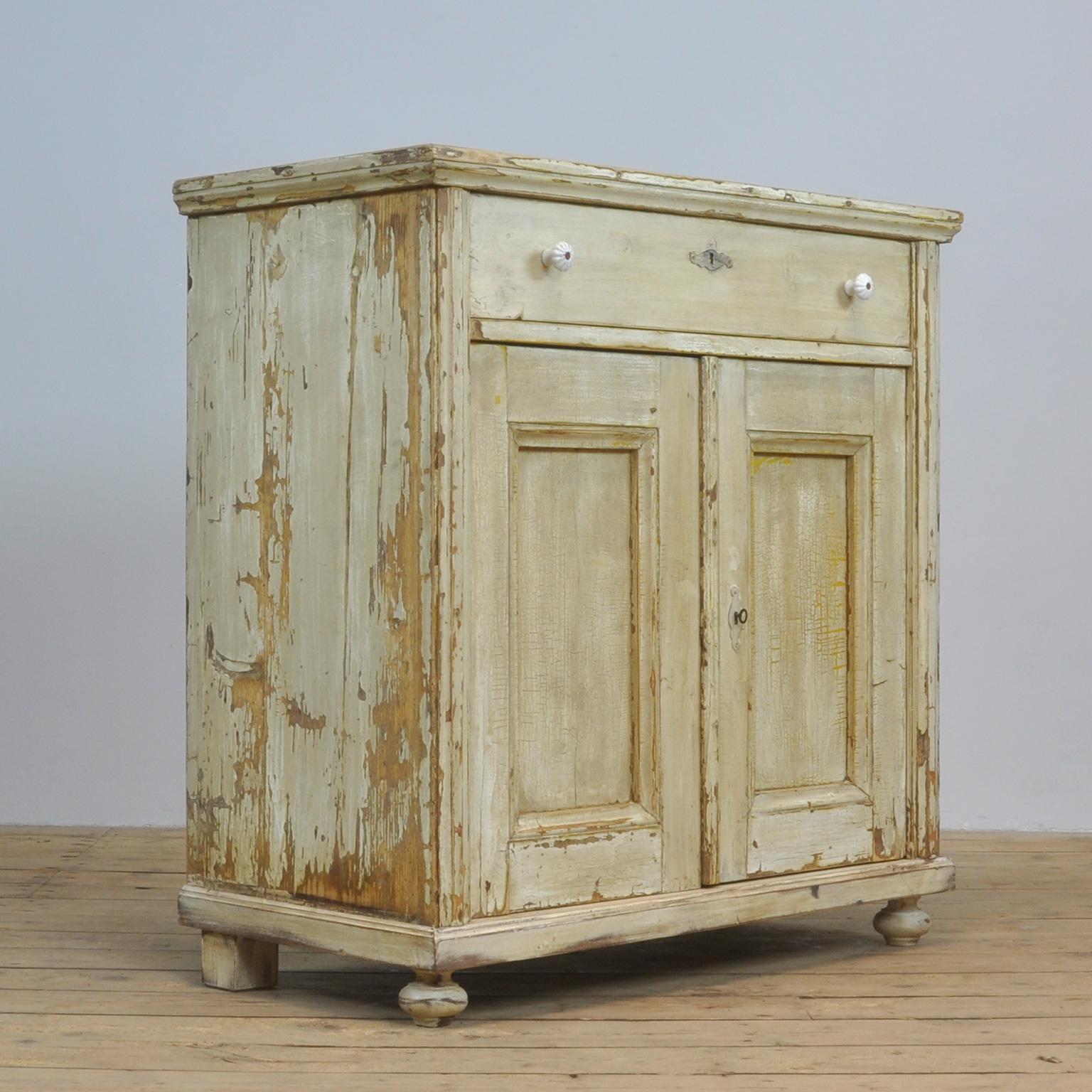 Dresser made of pine. Produced in the 1930s with a drawer and a shelf inside. Original paint.