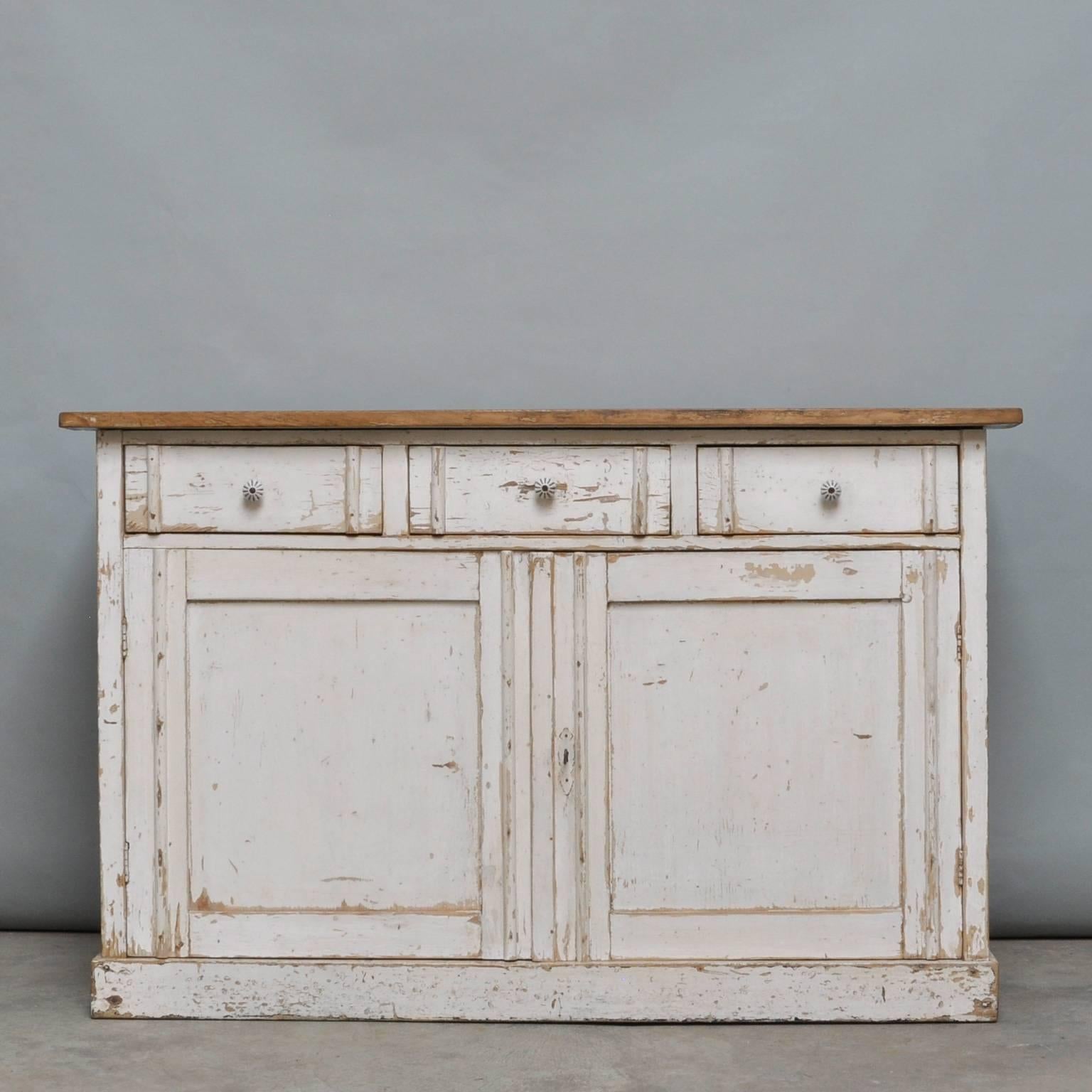 Dressoir made of pine. Produced in the 1930s on the inside three drawers and a shelf. Original paint.