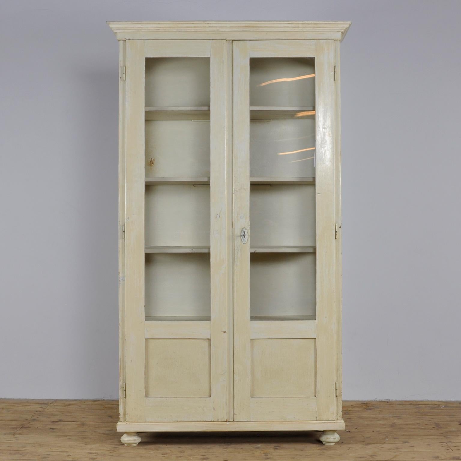 This Eastern European cabinet retains its original paint and pine interior. It features four shelves.