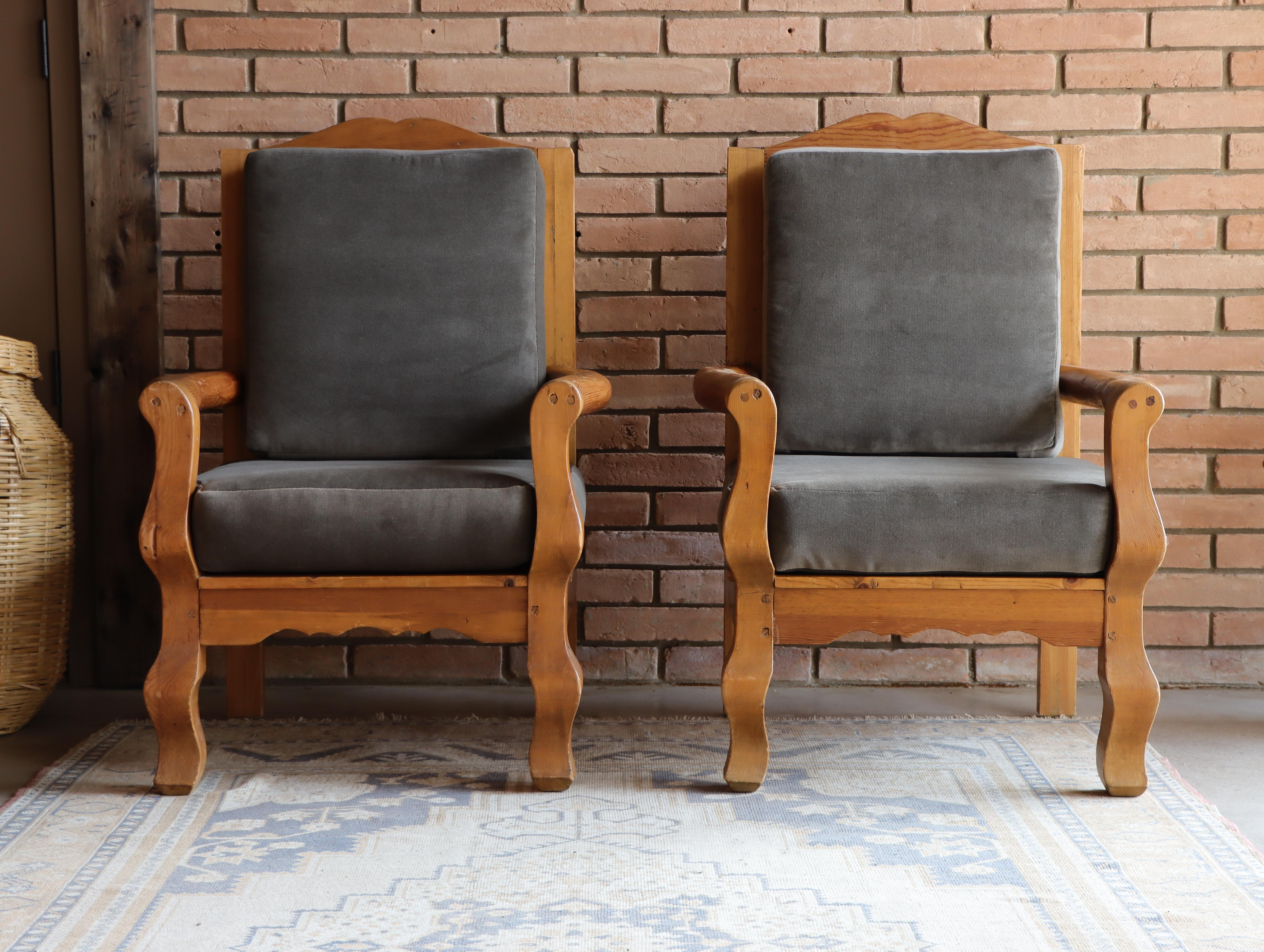 Beautiful vintage handmade Mexican arm chairs in the style of William Spratling. Executed in pine, these chairs show off wonderful movement and presence. Each cushion is upholstered in a soft gray velvet adding to their sophistication

Would be a