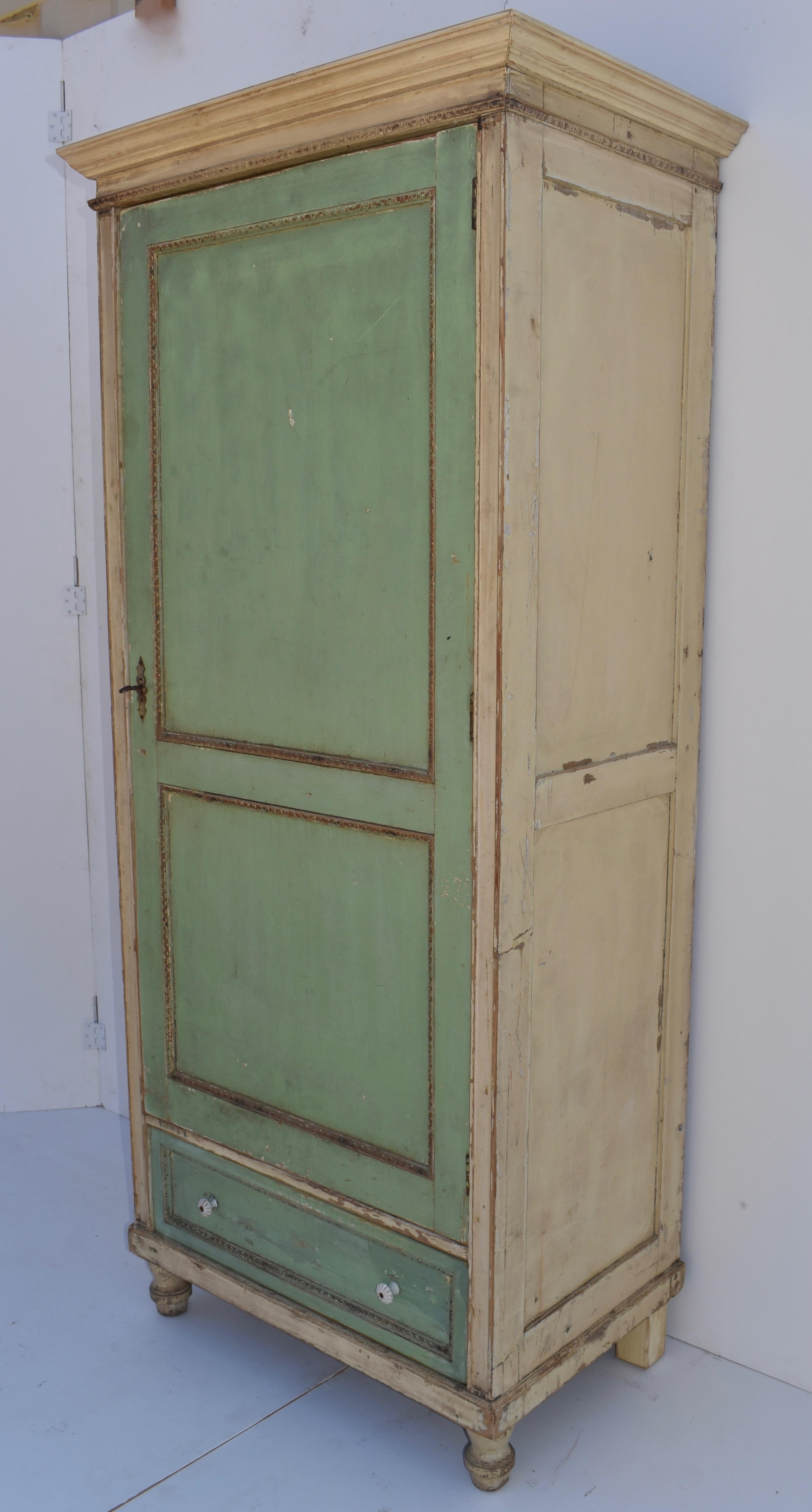 This relatively lightweight but sturdy chimney-style cupboard has one door with two assymetrical panels and one handcut dovetailed drawer. The veneered panels are bordered with egg and dart molding and the piece stands on tall turned feet. In old