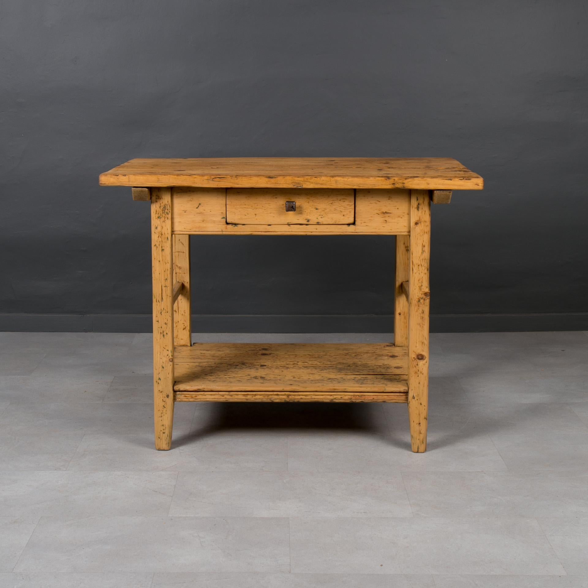 This charming vintage table was made in late 19th Century in Hungary. The whole piece is made of pine wood. The top is set on a solid base with a wide apron. One practical drawer resides in the apron. The piece was gently refreshed and finished with