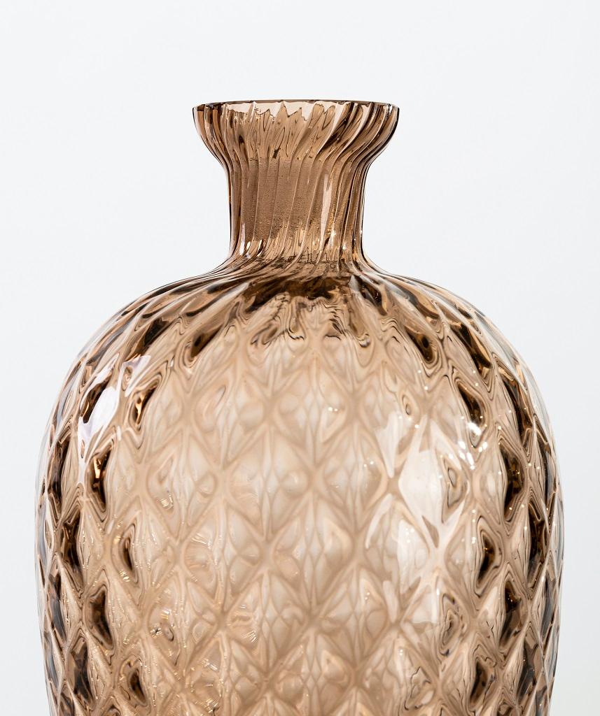Vintage pineapple vase is an original glass vase realized in the 1970s.

Very beautiful glass vase characterized by a surface with multi-faceted decoration.

Good condition except for a chipping on the higher part of the neck.