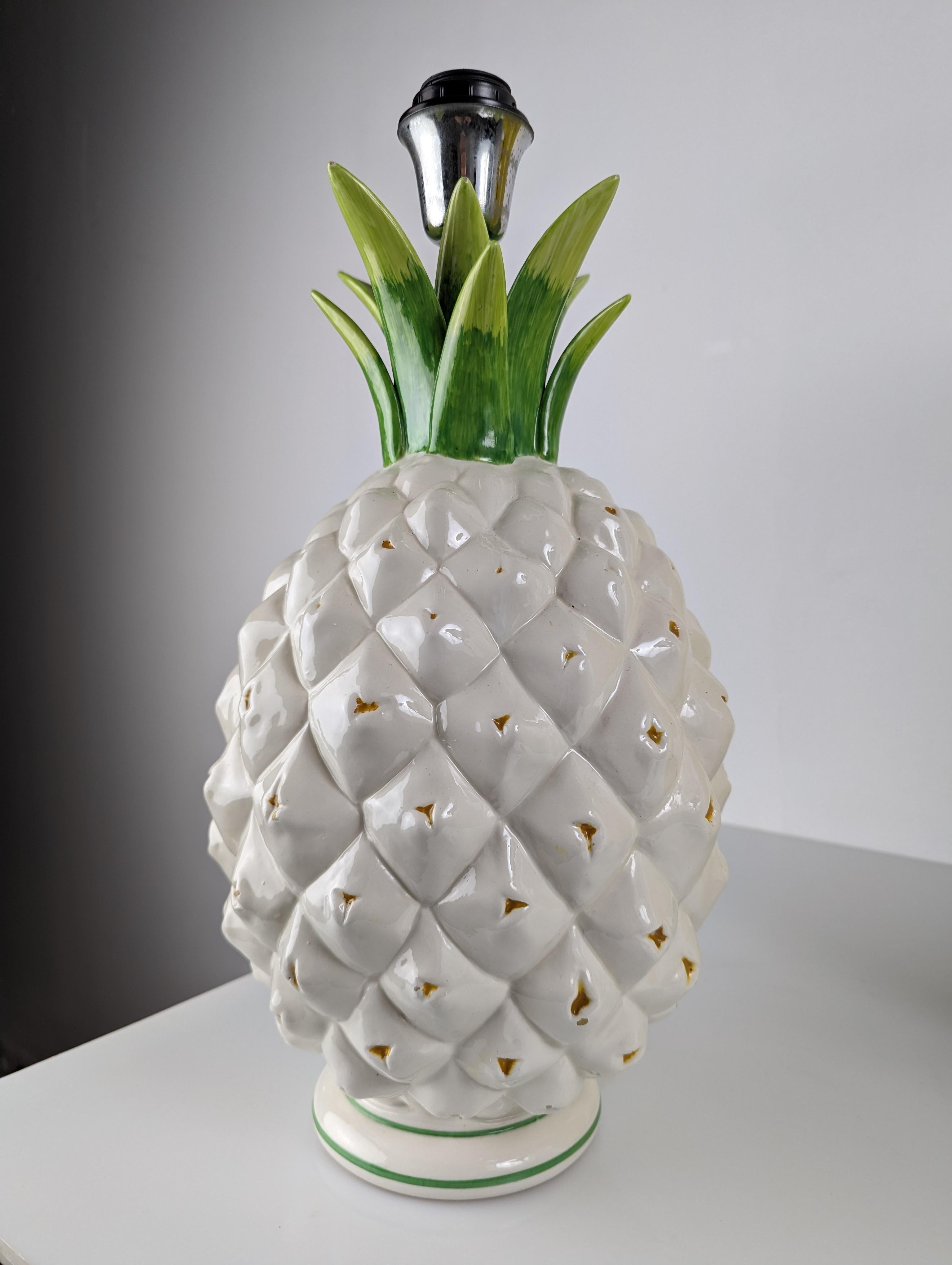 Pineapple lamp made of white, green ceramic and yellow details.