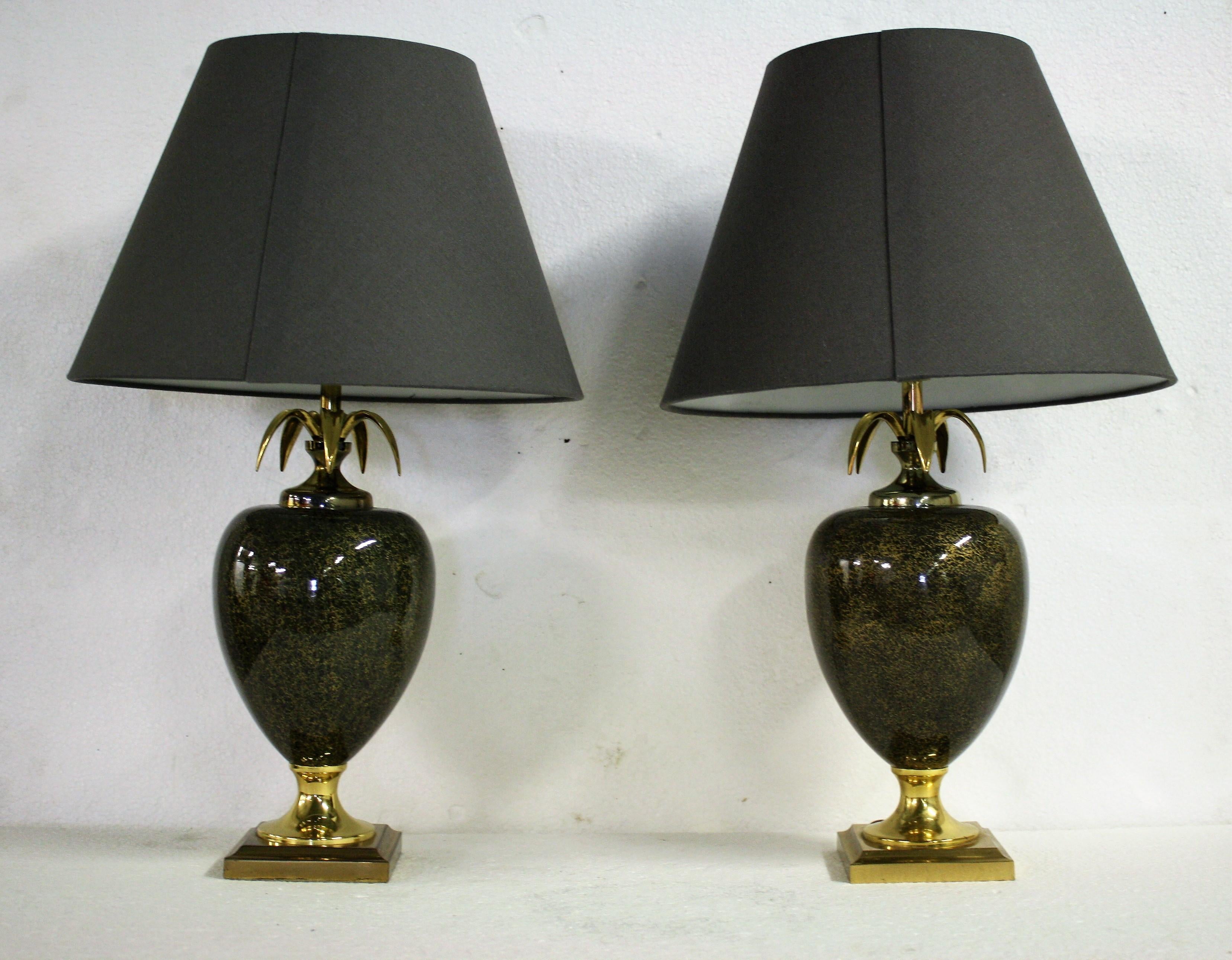 Beautiful brass and black metal pineapple table lamps by Maison Le Dauphin.

These luxurious lamps have an egg shaped center piece with golden accents finished with brass pineapple leafs.

The lamps are beautiful pieces in excellent