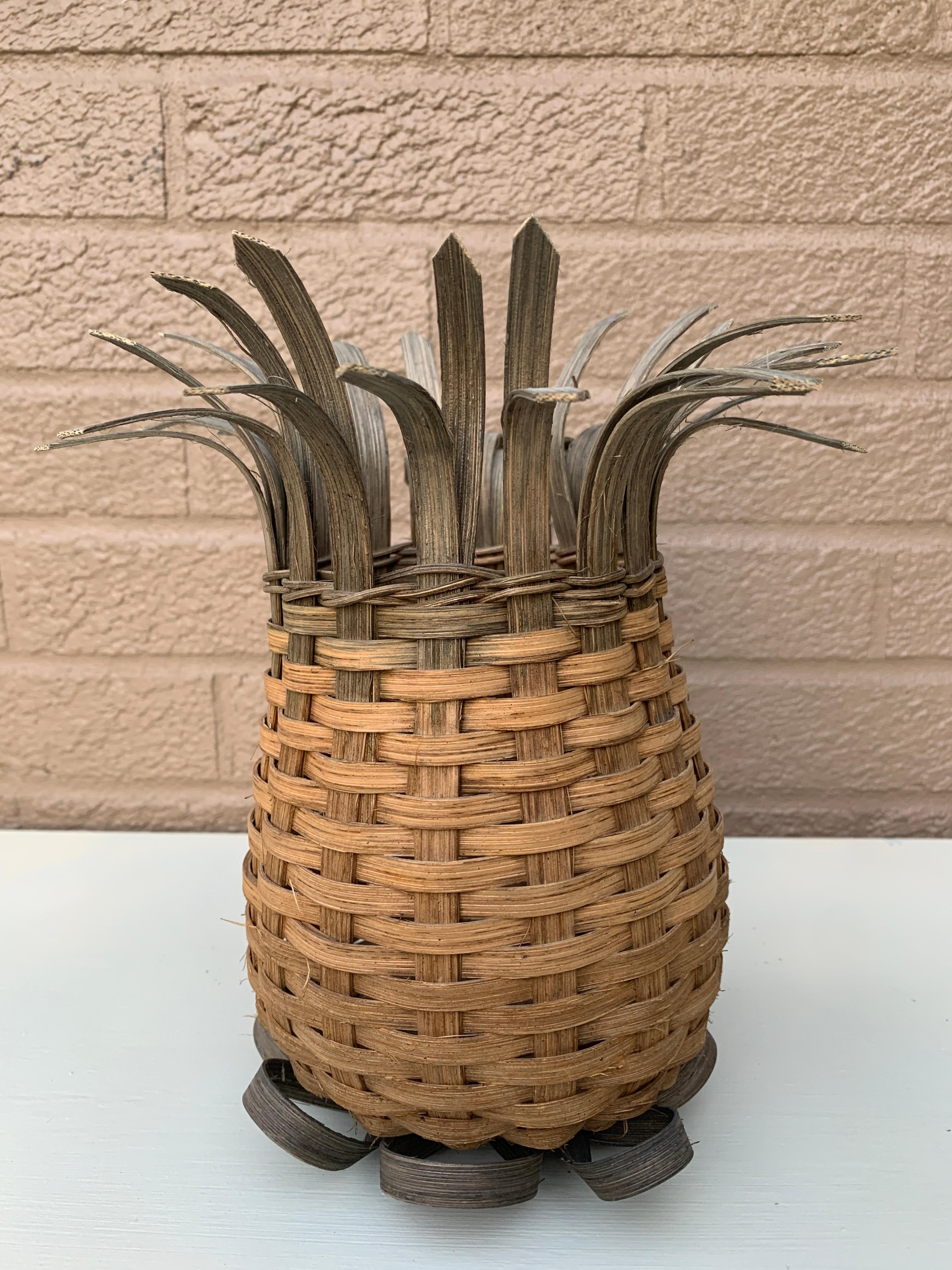 A charming woven wicker basket in the form of a pineapple. A glass vase could be inserted into this.

USA, Circa 1990s

Measures: 7.5