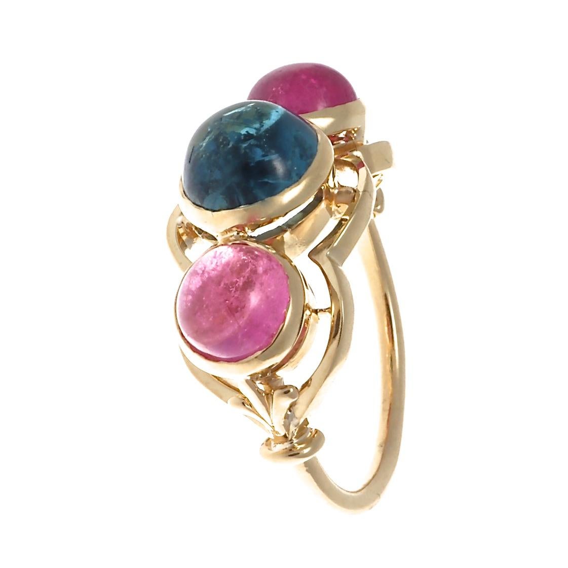 The pink and blue tourmaline for this lovely 18k setting is the perfect fit and complement one another so beautifully. The pink tourmaline cabochons weigh approximately 1.05 carats each, and one blue tourmaline weighs approximately 1.90 carats.