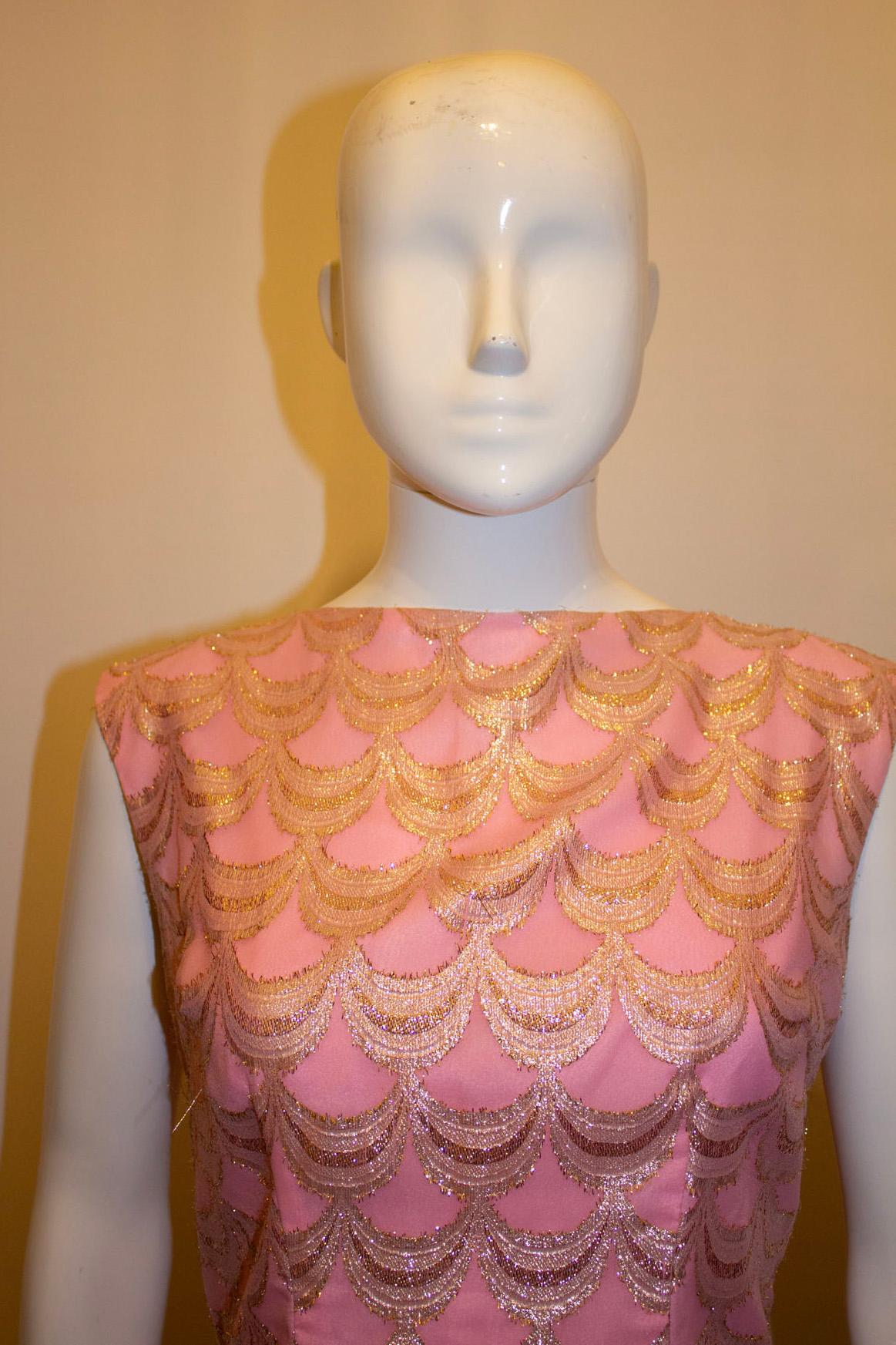 A pretty vintage evening gown , in pink with shades of gold. The dress has an attractive v backlline with a central back zip. It is sleaveless and fully lined.
Measurements: Bust up to 38'',length 58'' plus hem 2 1/2''.