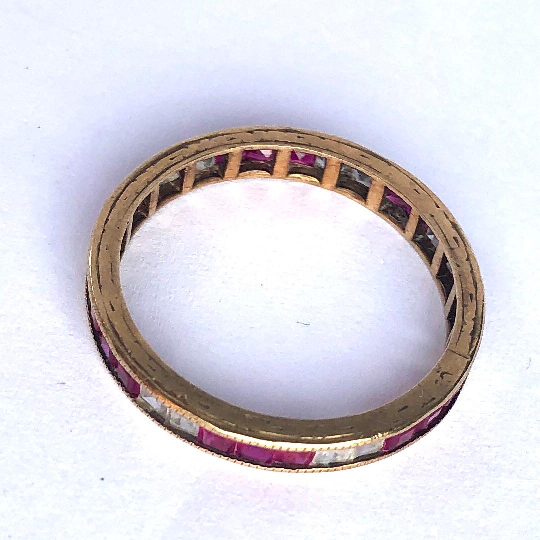 This eternity band holds rich pink square sapphires measuring 10pts each and in between these stones are white sapphires measuring 10pts each. The band is modelled in 9ct gold.

Ring Size: P 1/2 or 8 
Band Width: 2mm 

Weight: 1.67g