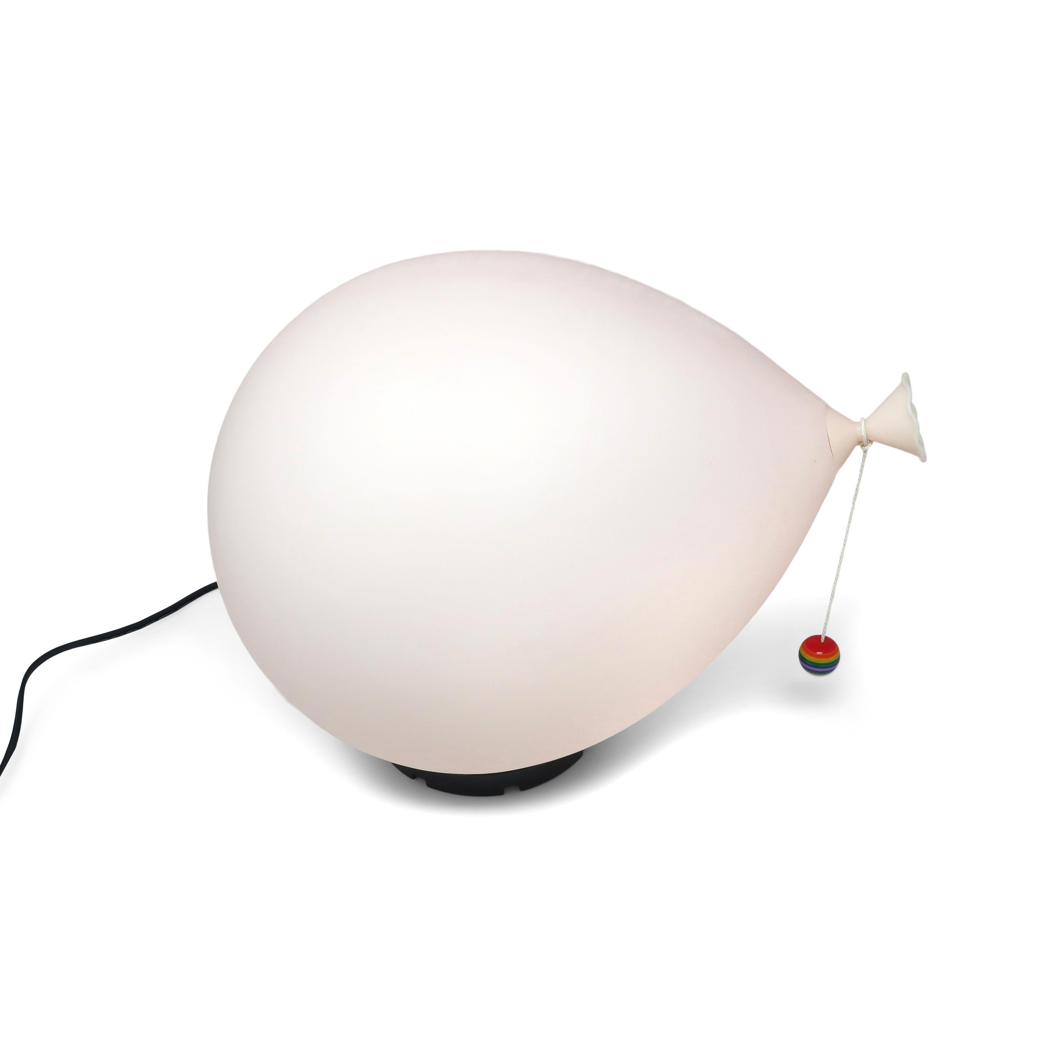 An iconic Italian balloon lamp designed by Yves Christin for Bilumen in 1975. This is the middle of the three sizes and has a soft pink colored balloon, black base, and rainbow bead at the end of the strong. 

In excellent vintage condition with