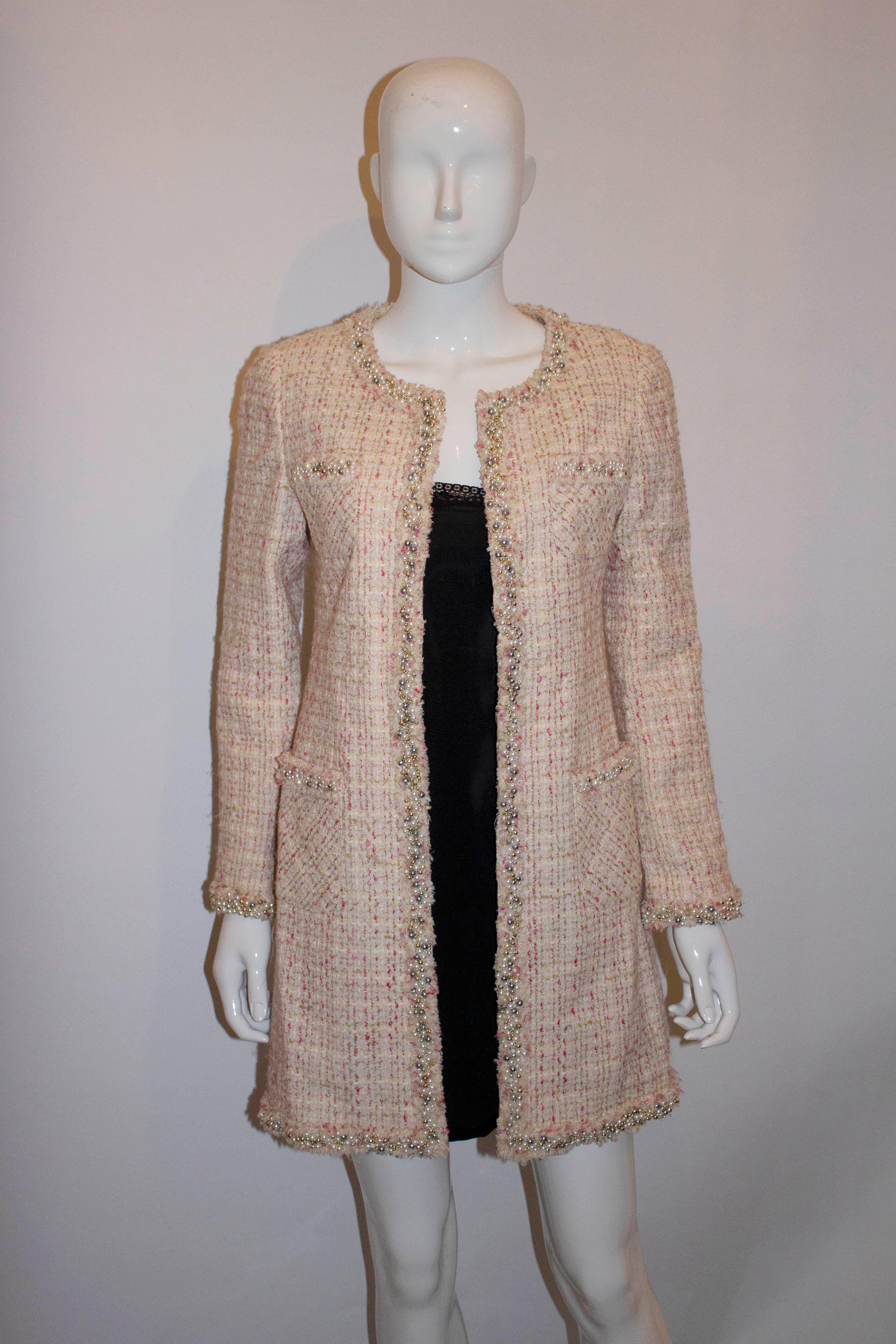 A great coat /jacket for Spring /Summer.  In a pink fabric with pearl, gold and silver bead decoration and fringe detail, the coat has four pockets and is fully lined. Measurements : Bust 36'', length 35''