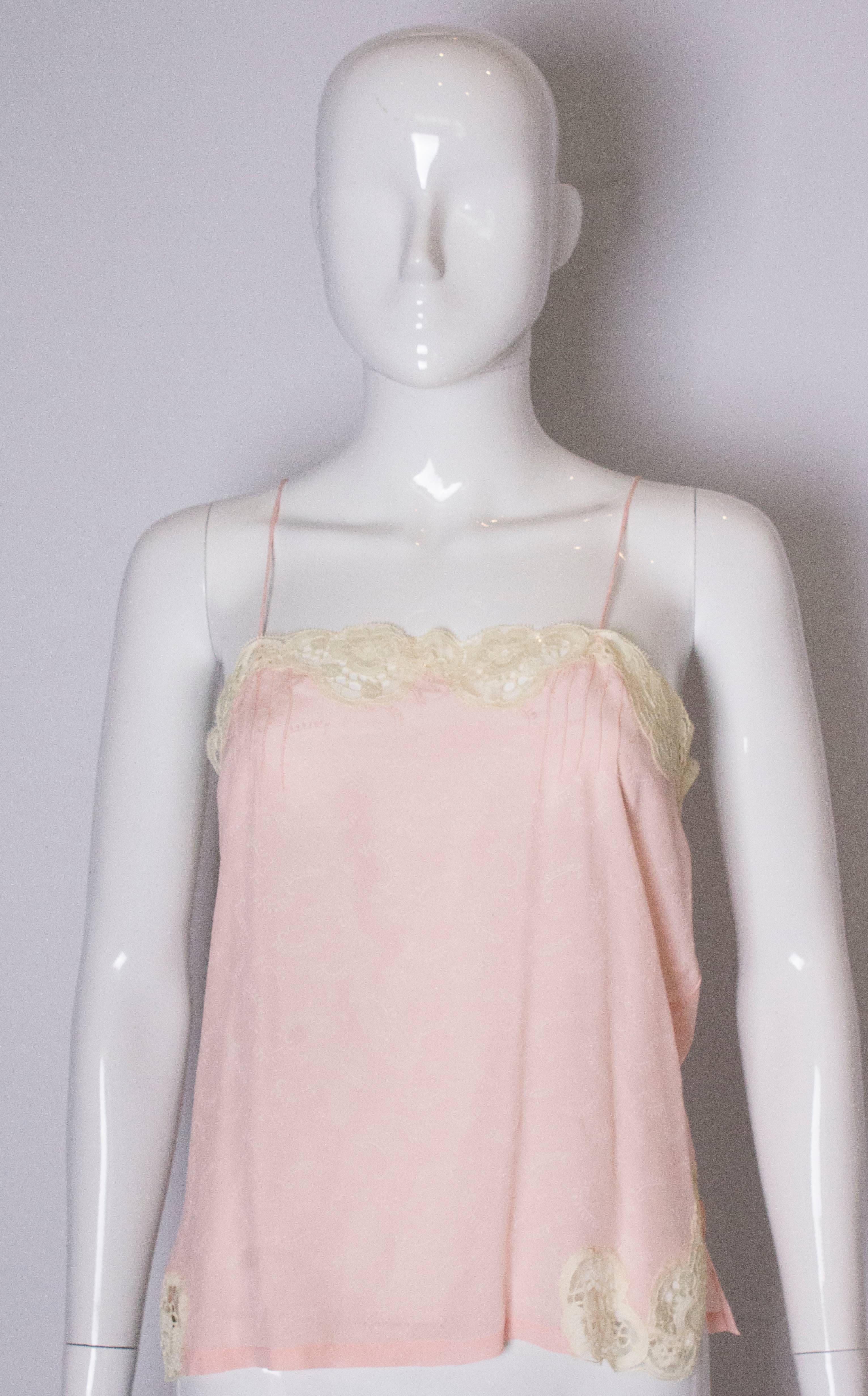 A pretty vintage cami top with lace detail  and pin tucks.
