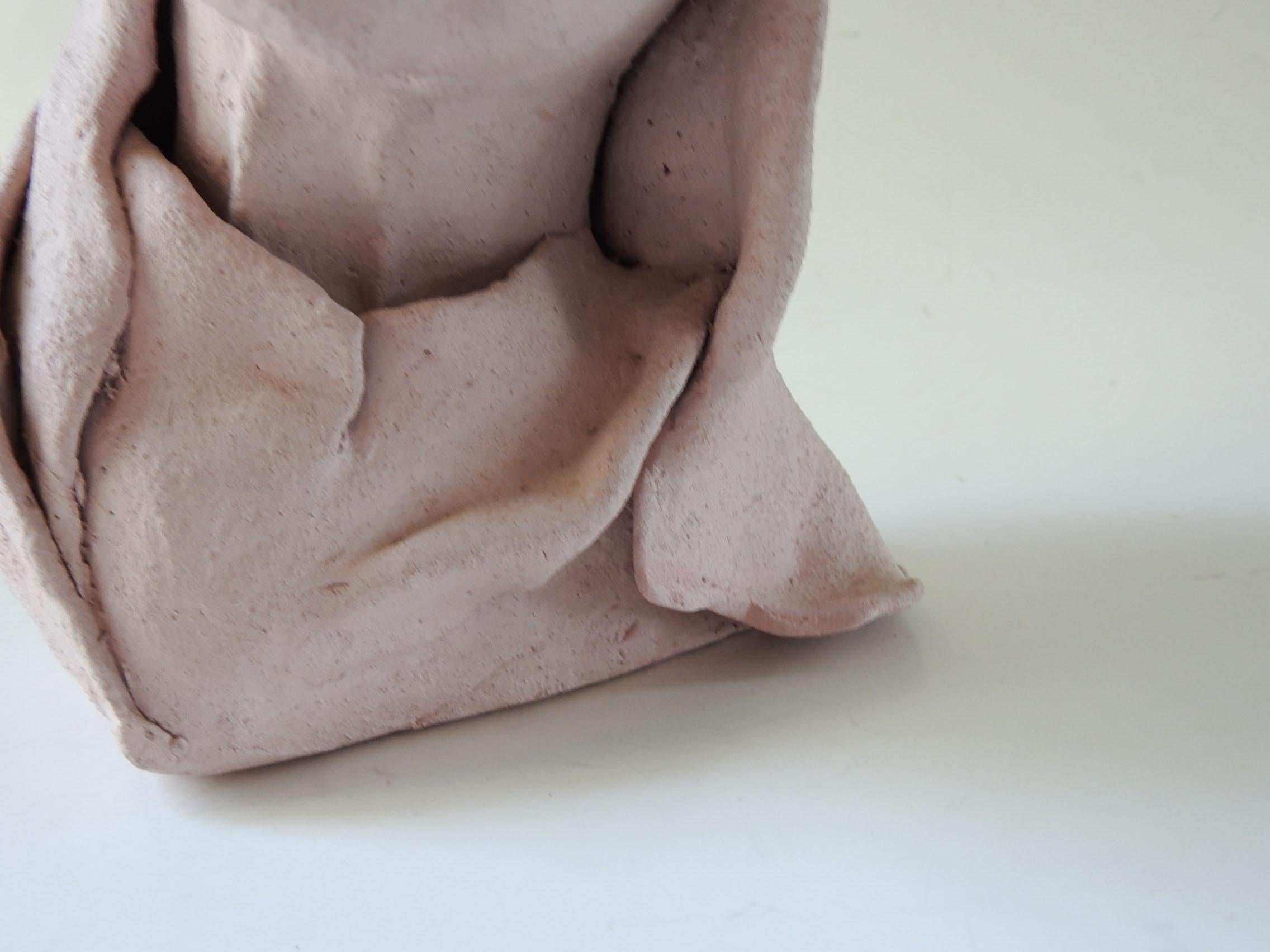 Vintage pink clay bust of woman in headdress.  Unsigned.  Looks like small chip on edge of scarf.
