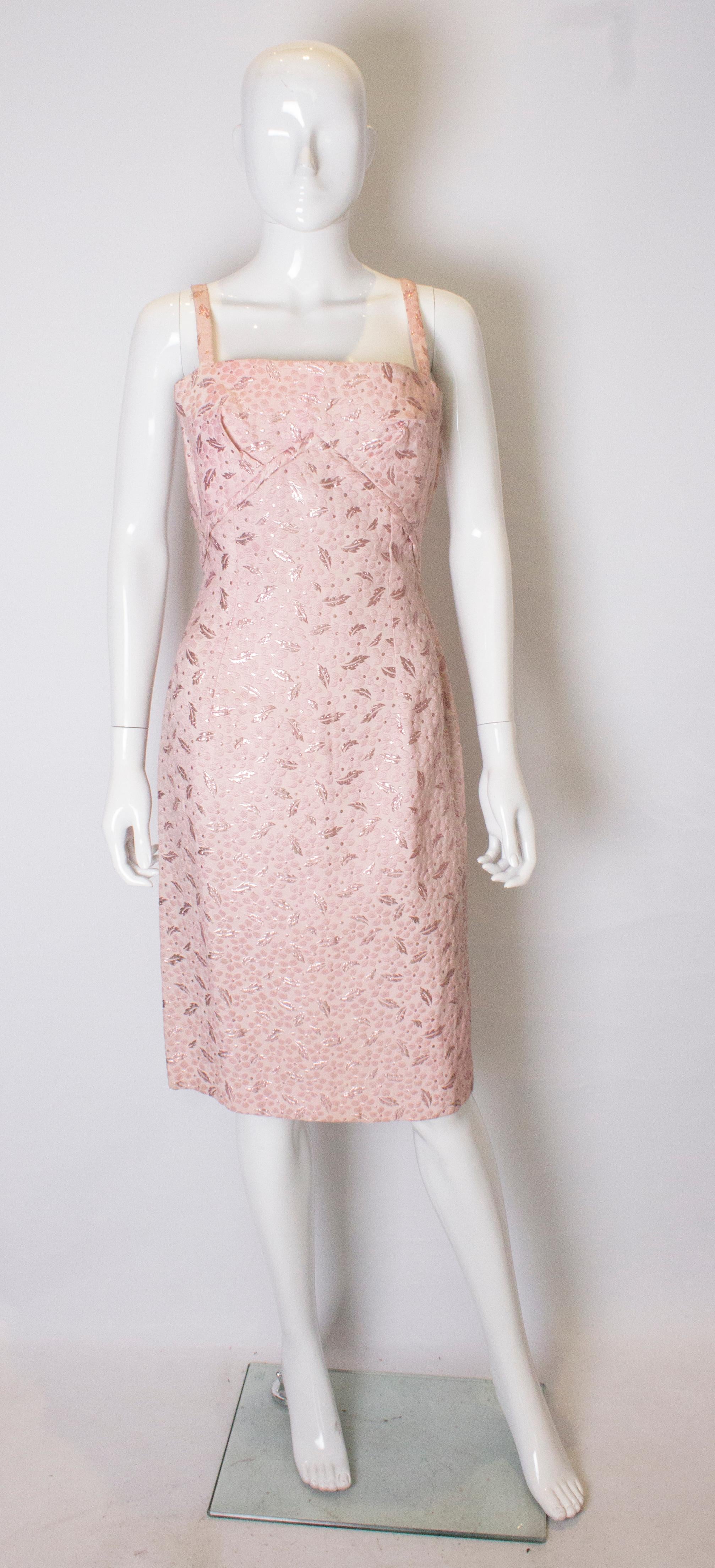 A chic dress for Spring / Summer. In a  pretty textured pink fabric,  this dress has spagetti straps , a floral print, , side zip opening and folds under the bust. The dress is unlined.