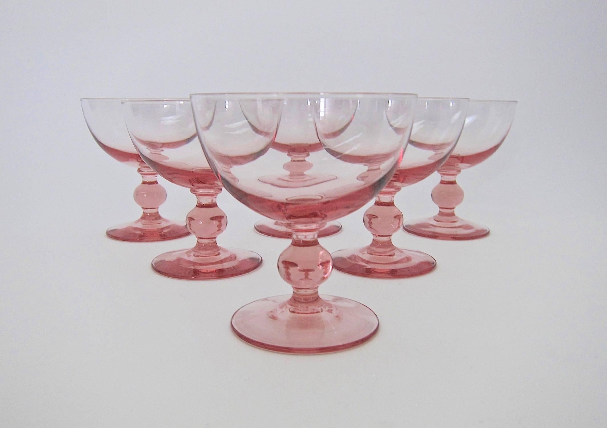 A vintage set of six coupe glasses in pale pink with knopped stems, perfectly sized for champagne, cocktails, or sherbet.

Unmarked and in very good condition, measuring 4 in. H x 3.75 in. Diameter (at rim); each glass holds 7 oz. filled to the