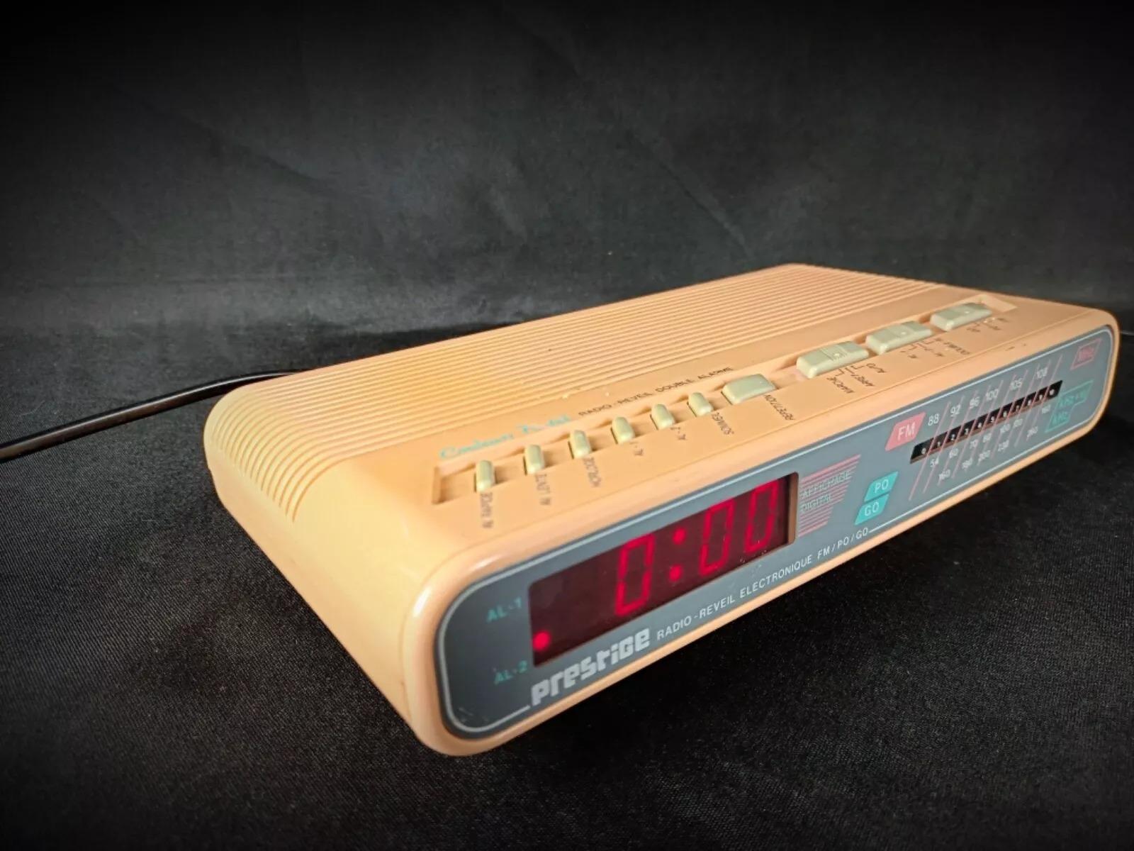 Add a touch of retro charm to your space with this vintage pink electronic alarm clock radio by Prestige, model No. 736. Designed for both style and functionality, this elegant piece combines classic design with modern convenience, featuring FM, AM,