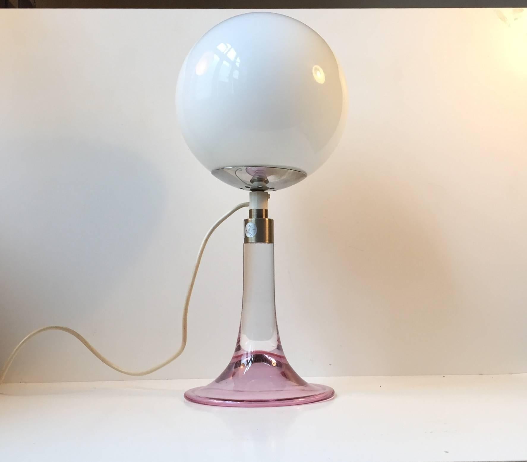 Trumpet-shaped table light in pink glass - called fanfare. Manufactured and designed by Royal Copenhagen in collaboration with Holmegaard in Denmark. It is mounted with an opaline glass shade. Sticker from RC is still present to the base.