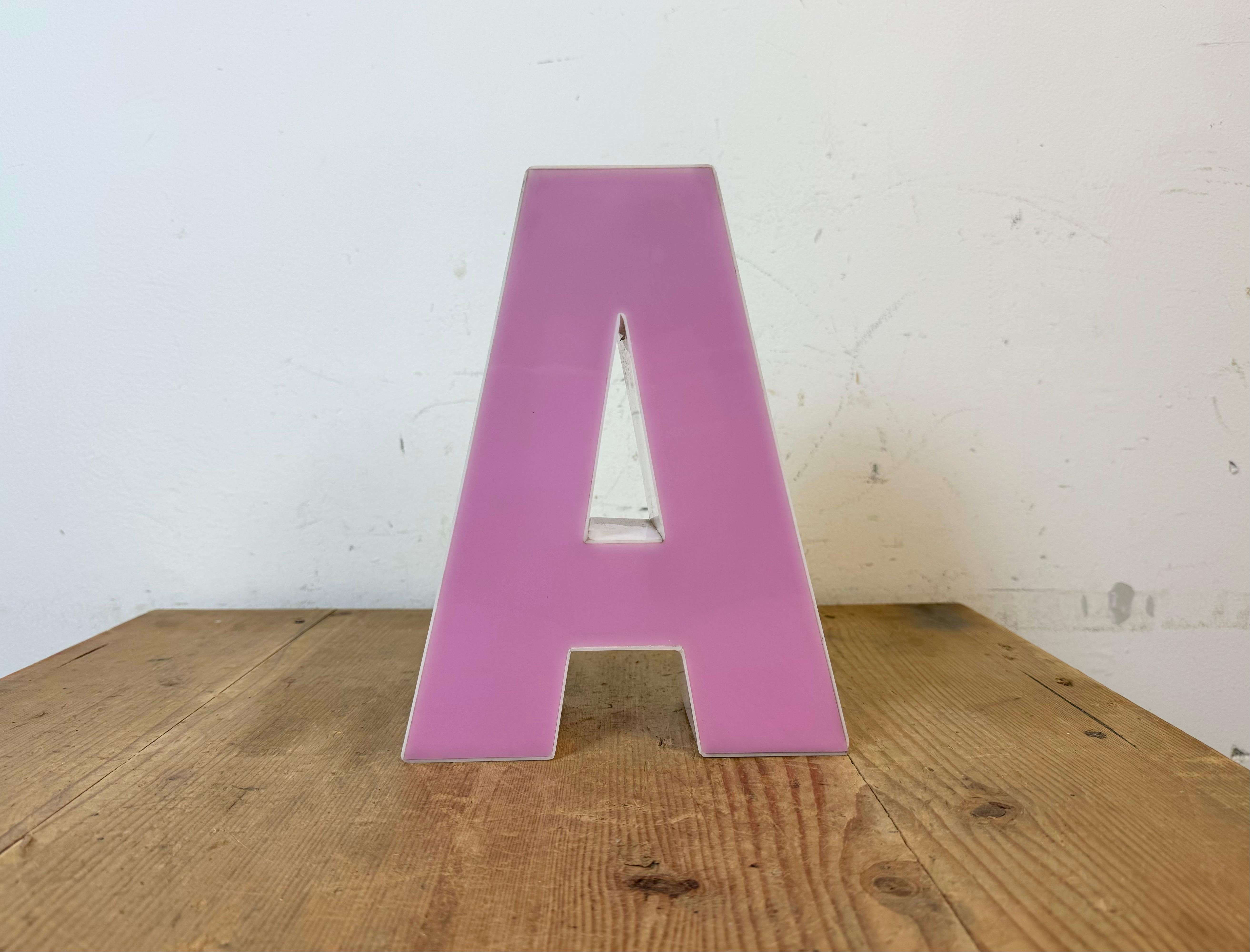 This vintage industrial plastic illuminated facade letter A was made in Italy during the 1970s and comes from an old advertising banner. It is equipped with a LED strip. The letter can be used as a table lamp or wall lamp.The weight of the letter is