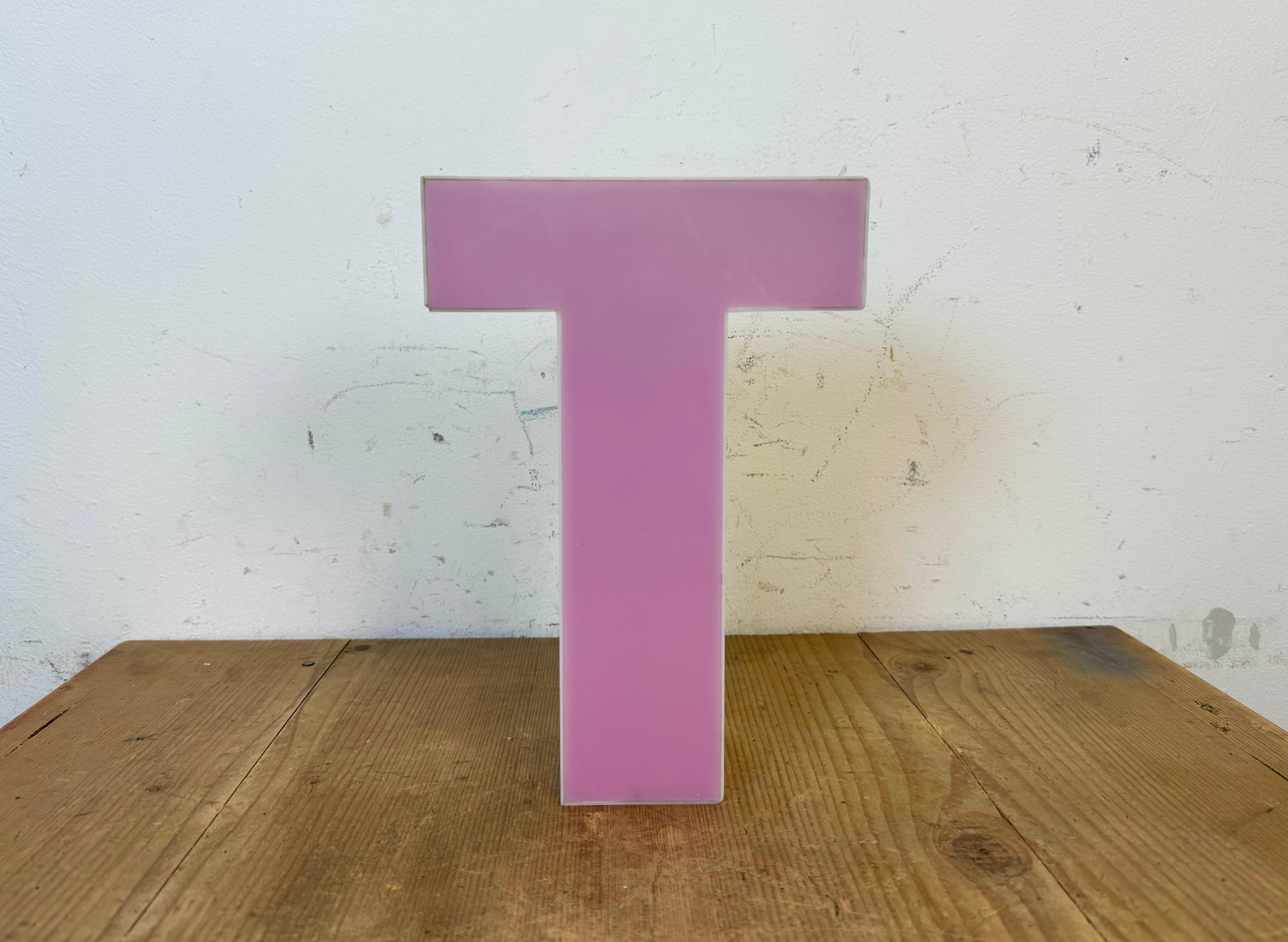 This vintage industrial plastic illuminated facade letter T was made in Italy during the 1970s and comes from an old advertising banner. It is equipped with a LED strip. The letter can be used as a table lamp or wall lamp.The weight of the letter is
