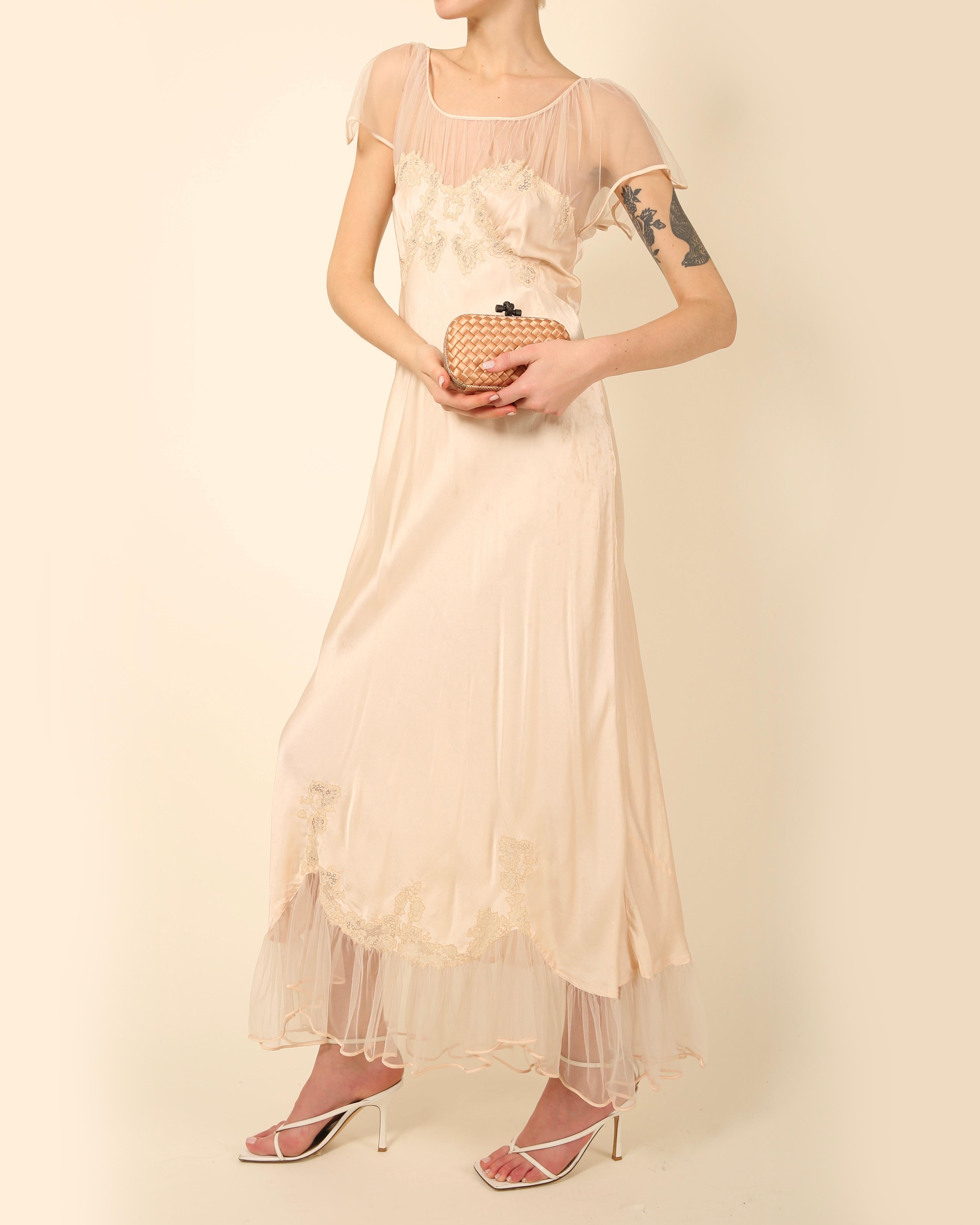 A beautiful vintage silk nightgown in pale pink that could easily be worn as a dress in the evening teamed with a pair of sandals or high heels
Sheer mesh (tulle) upper and ruffled hem
Lace embroidered floral detail to the bust
Bias cut
Maxi