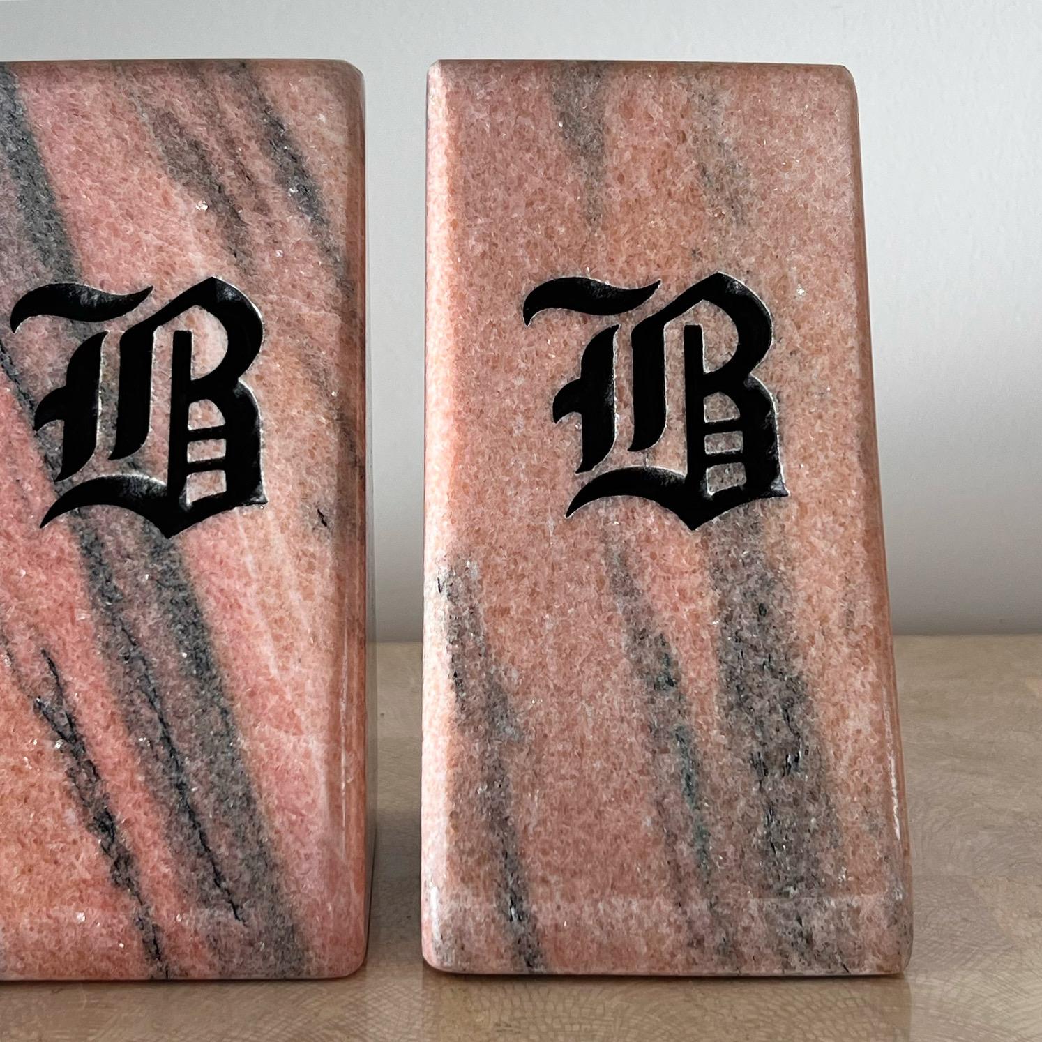 A very unique pair of monumental bookends in triangular chunks of pink marble, late 20th century. Each has the initial “B” in Gothic lettering carved into the back and painted black. A special item for anyone who feels some significance towards the