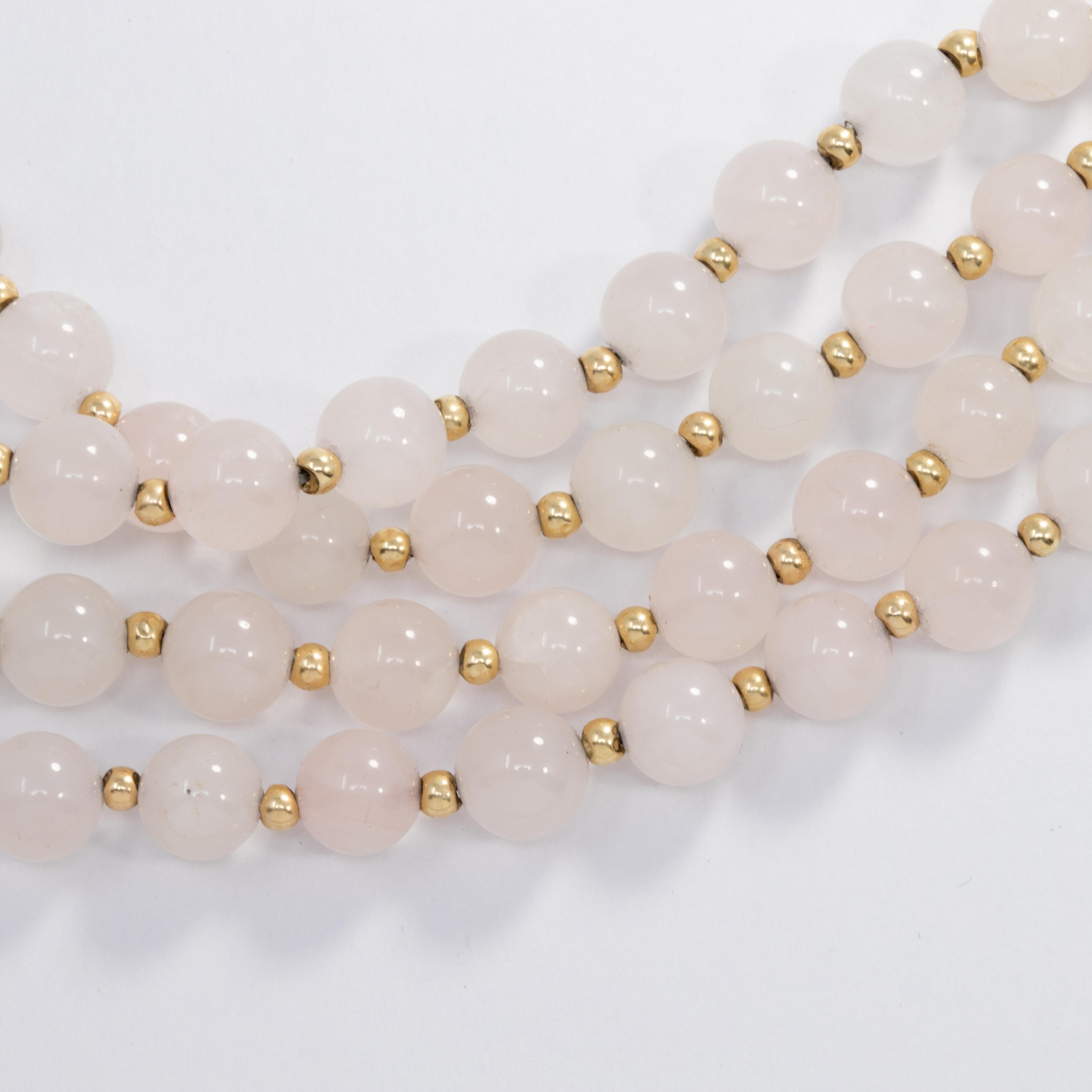 Long necklace featuring a single strand of opaque white quartz beads accented with gold findings. Extravagant!