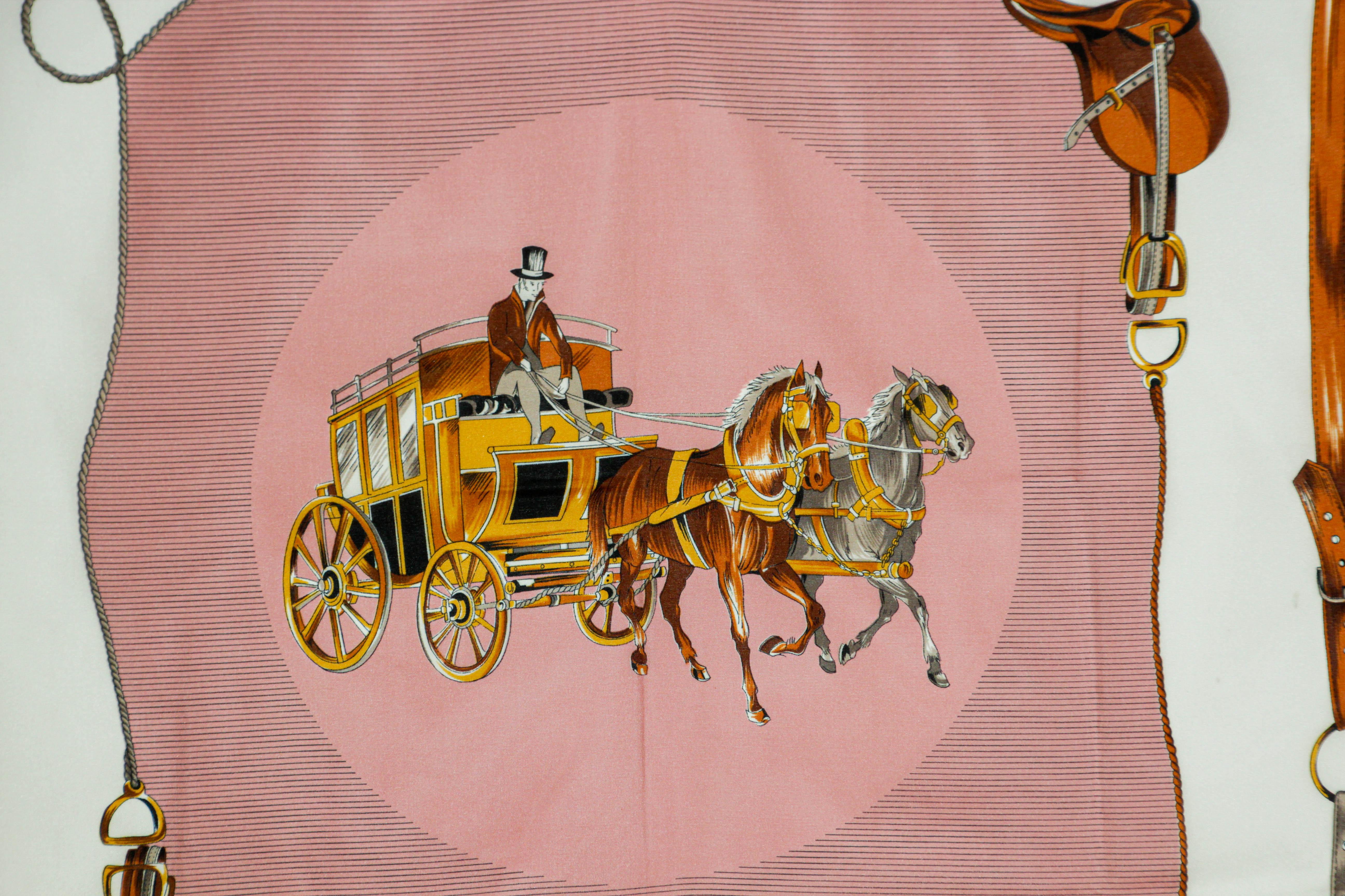 Vintage pink scarf with horse carriages motif.
1970’s vintage Gina Renoir equestrian scarf featuring a coachman on a stagecoach pulled by 2 horses. Dark brown border along with various equestrian tack items, saddles, stirrups and leather work. 
In