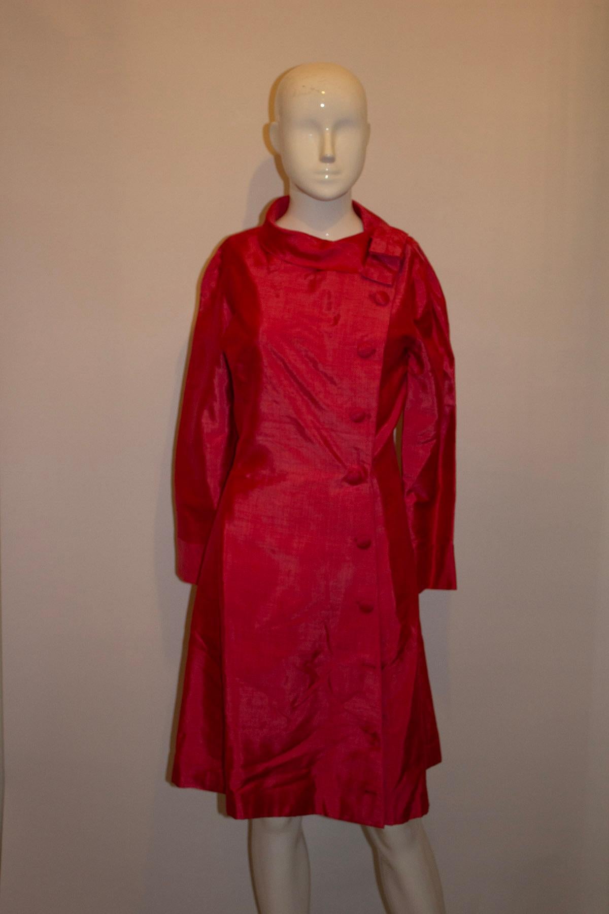 A wonderful vintage coat dress, in a pretty pink silk with wonderful tailoring. The coat dress has an off centre button opening - with covered buttons and great tailoring.
Measurements: Bust 36'' waist 28'' ,length 39''