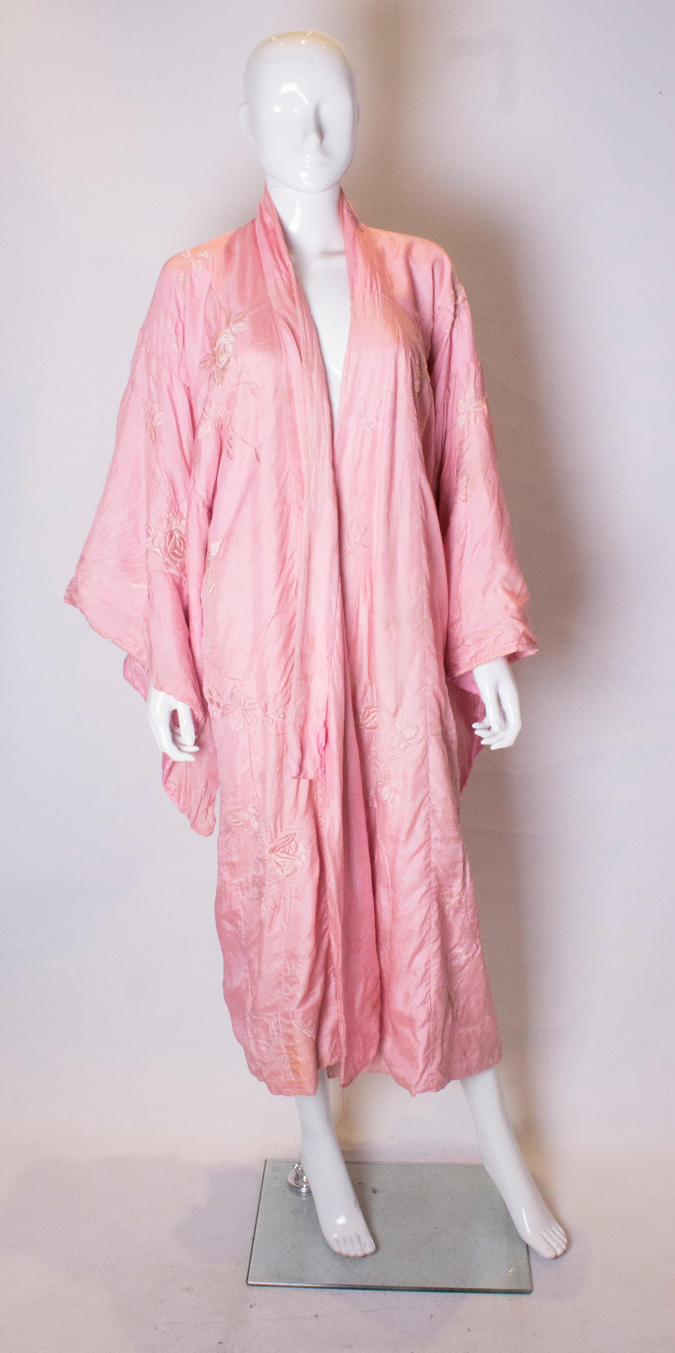 A pretty pink silk vintage kimono. This kimono is hand sewn with wonderful embroidery on the front and back.   Measurements : bust up to 42'' ,length 51''