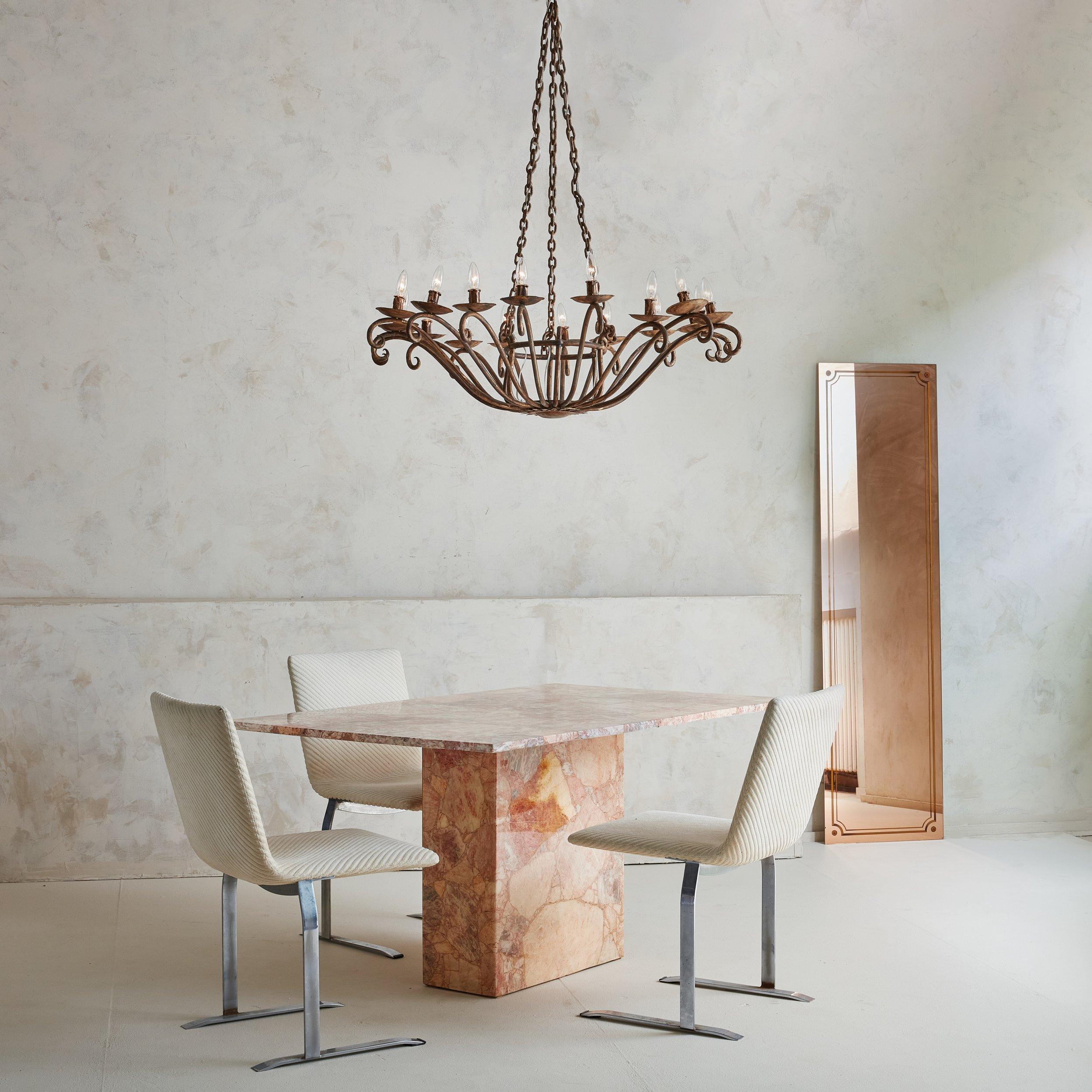 A completely stunning stone dining table from the 1970s featuring pink and peach stone. Assembled in a terrazzo style format, large pieces of stone quarried in Mexico have been assembled together to form the table top and rectangular base. 
 

