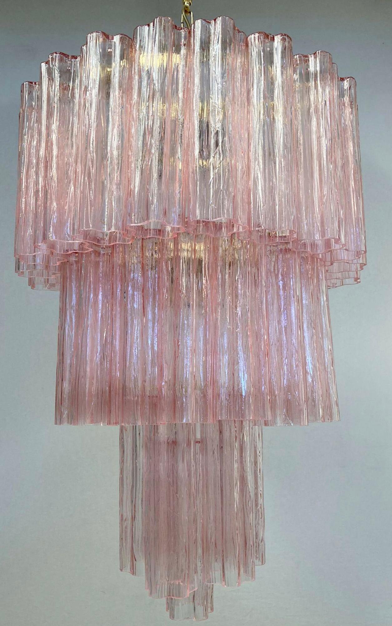 Vintage Italian chandelier with pink hand blown Murano Tronchi glasses arranged in 3 tiers, mounted on brass frame / Made in Italy circa 1960s
Measures: diameter 21.5 inches, height 31.5, total height 43.5 inches including chain canopy