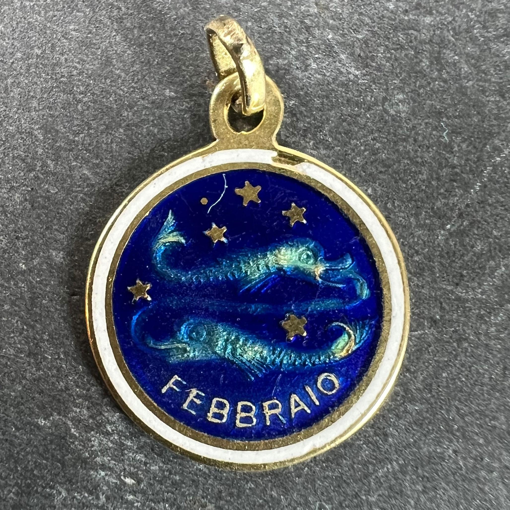 A vintage 18 karat (18K) yellow gold charm pendant designed as a circular medal with enamel depicting a pair of fish representing the zodiac star sign of Pisces in a constellation of stars with the word Febbraio (February) beneath. Unmarked but