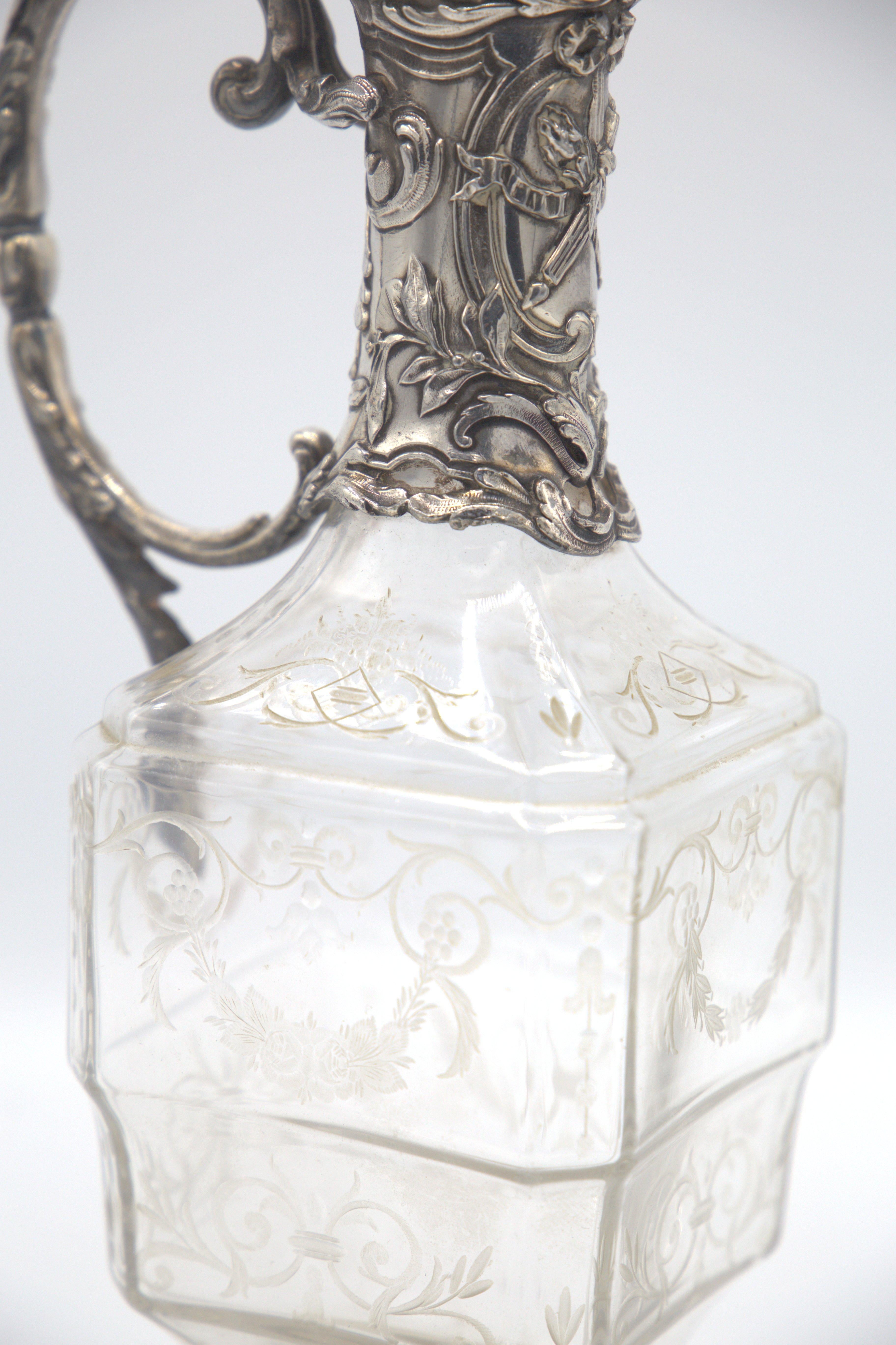 Gorgeous silver jug of Baracat production, late 1800s.
The jug is made of worked and carved silver in the round base and spout, while the central body is made of glass.
The spout opens through an elongation of the cap that closes, has the shape of