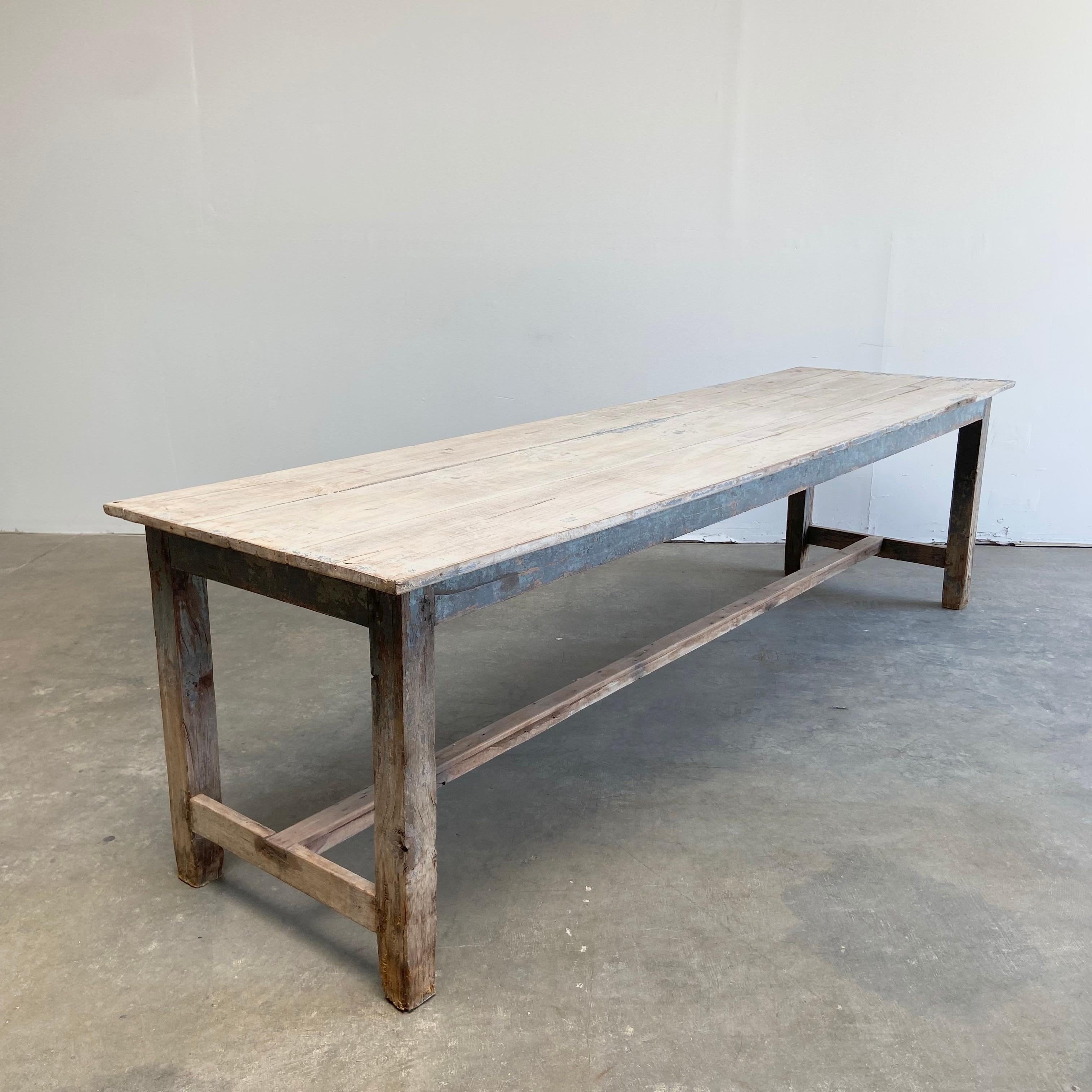 Vintage plank wood farm table with original paint
Size: 108”L x 30”D x 30”H
Clearance under apron: 25-1/2”H
Solid and sturdy ready for everyday use. This beautiful farm style dining table has some original gray blue paint with exposed wood.

    