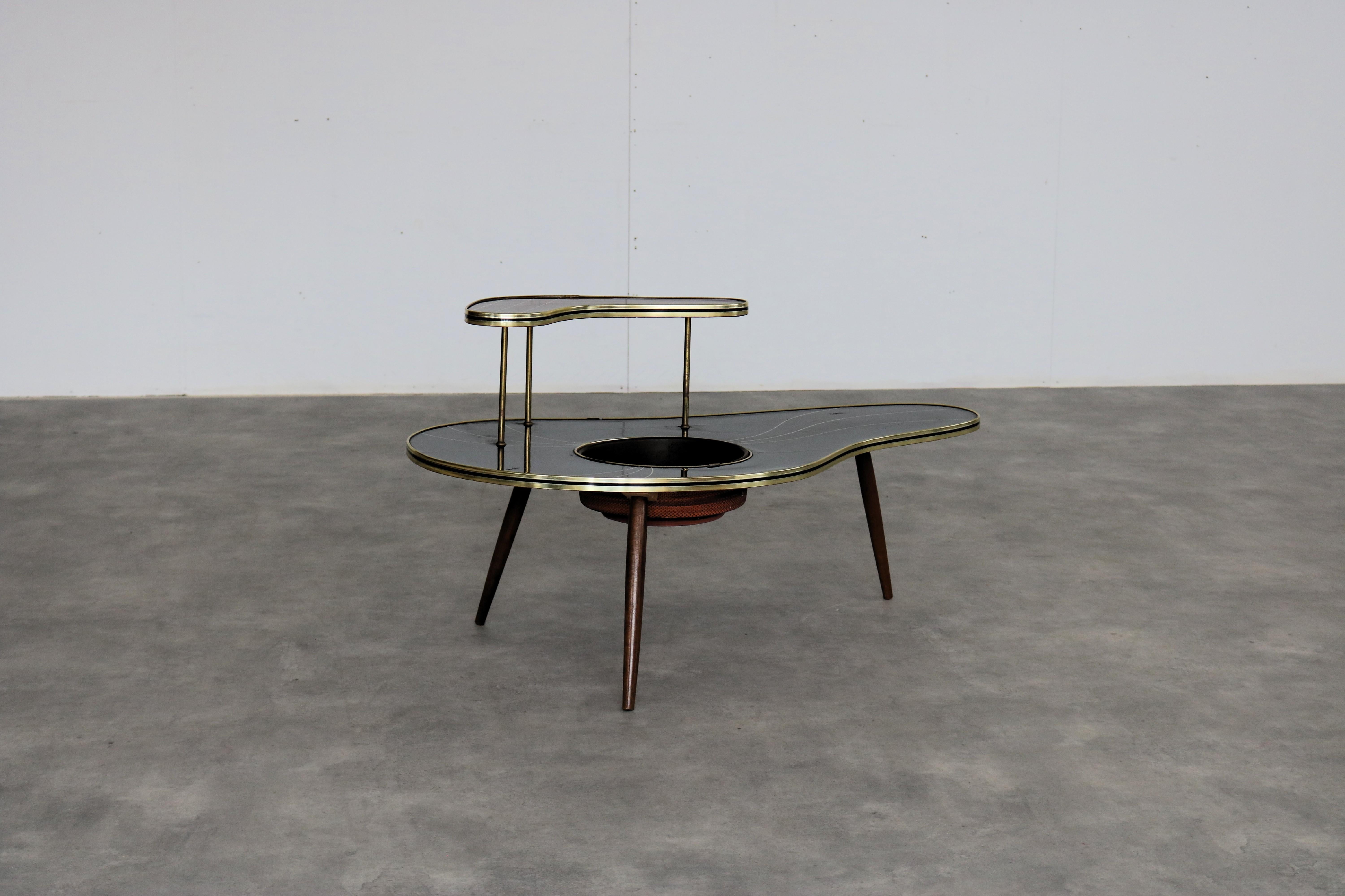 Vintage plant table  side table  1960s  Sweden

Period  1970s
Design  Unknown  Sweden
Condition  Good  Minor signs of wear
Size  52 x 98 x 60 cm (H x W x D)

Details  Wood; Brass; Ceramic; Plastic;

Item number  2889