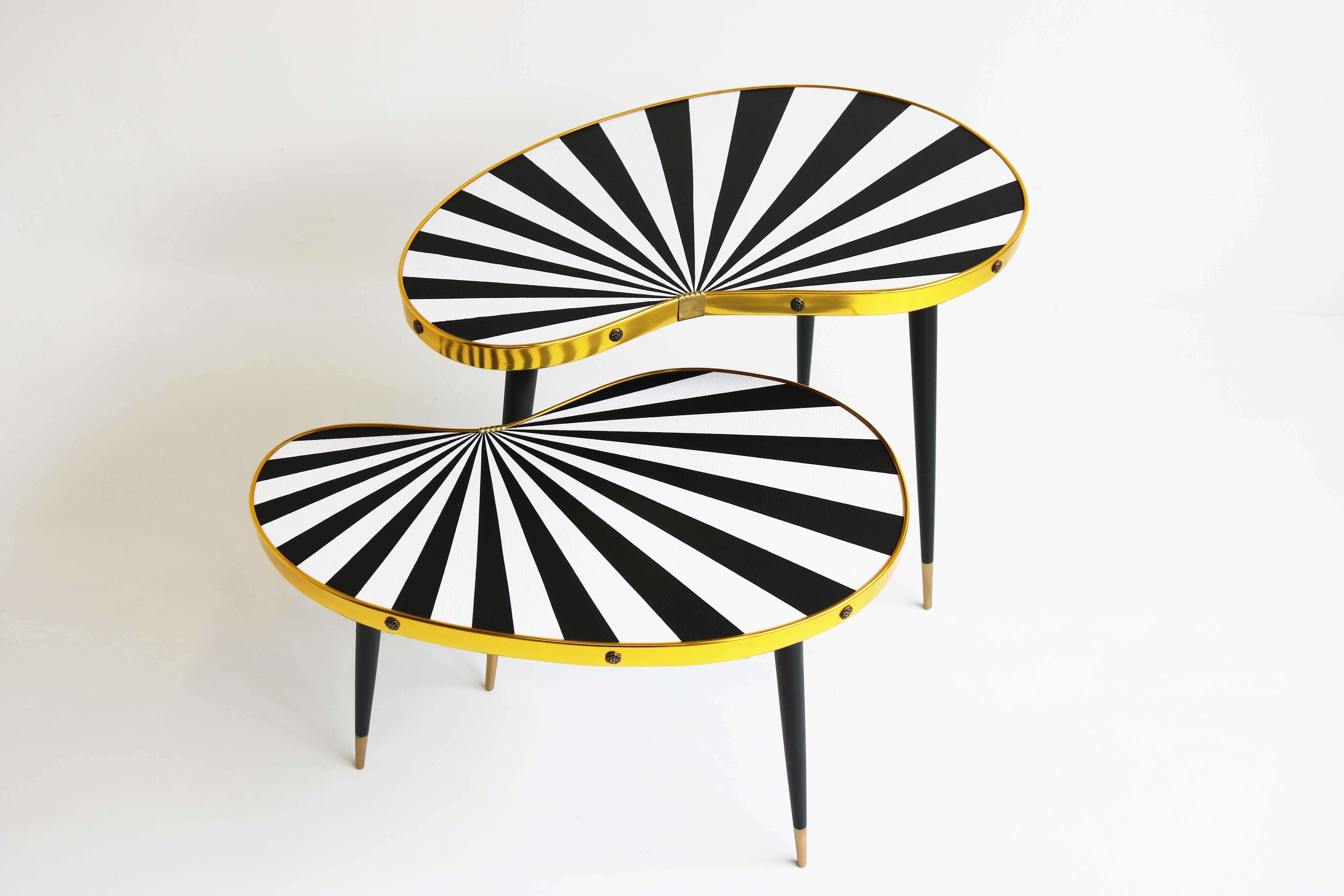 Two Mid-Century Modern German plant tables, side tables 1950-1974

You are looking at a stunning vintage plants table set.
Two decorative side tables, kidney shaped with black and white ray pattern.
The elegant slender legs give the table its