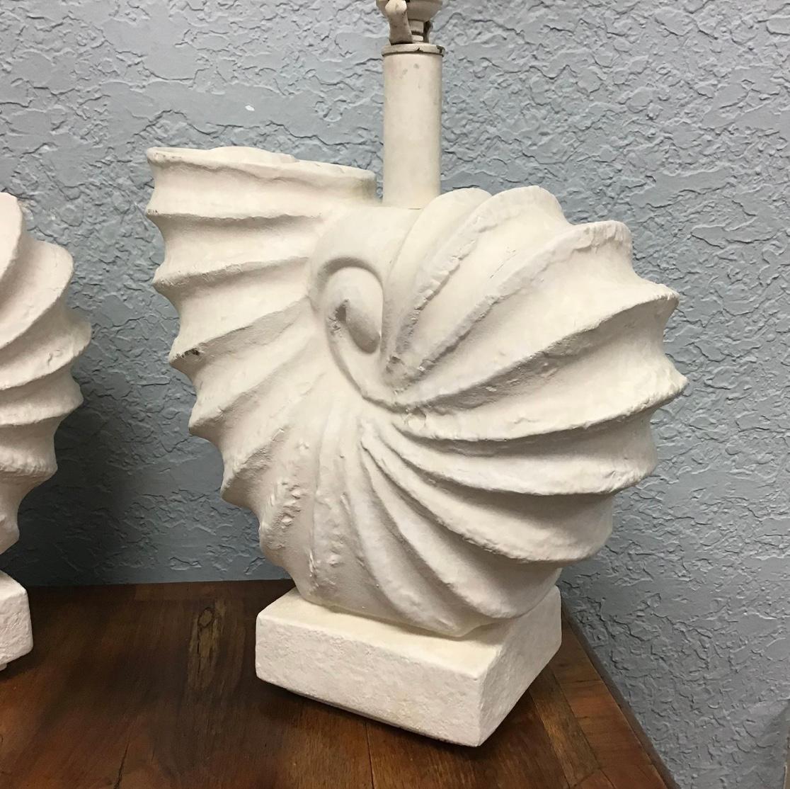 Pair of rare white plaster nautilus or ammonite table lamps. These are a rare to find in this style. They are vintage lamps and are wired and ready for use. Probably Sirmos.