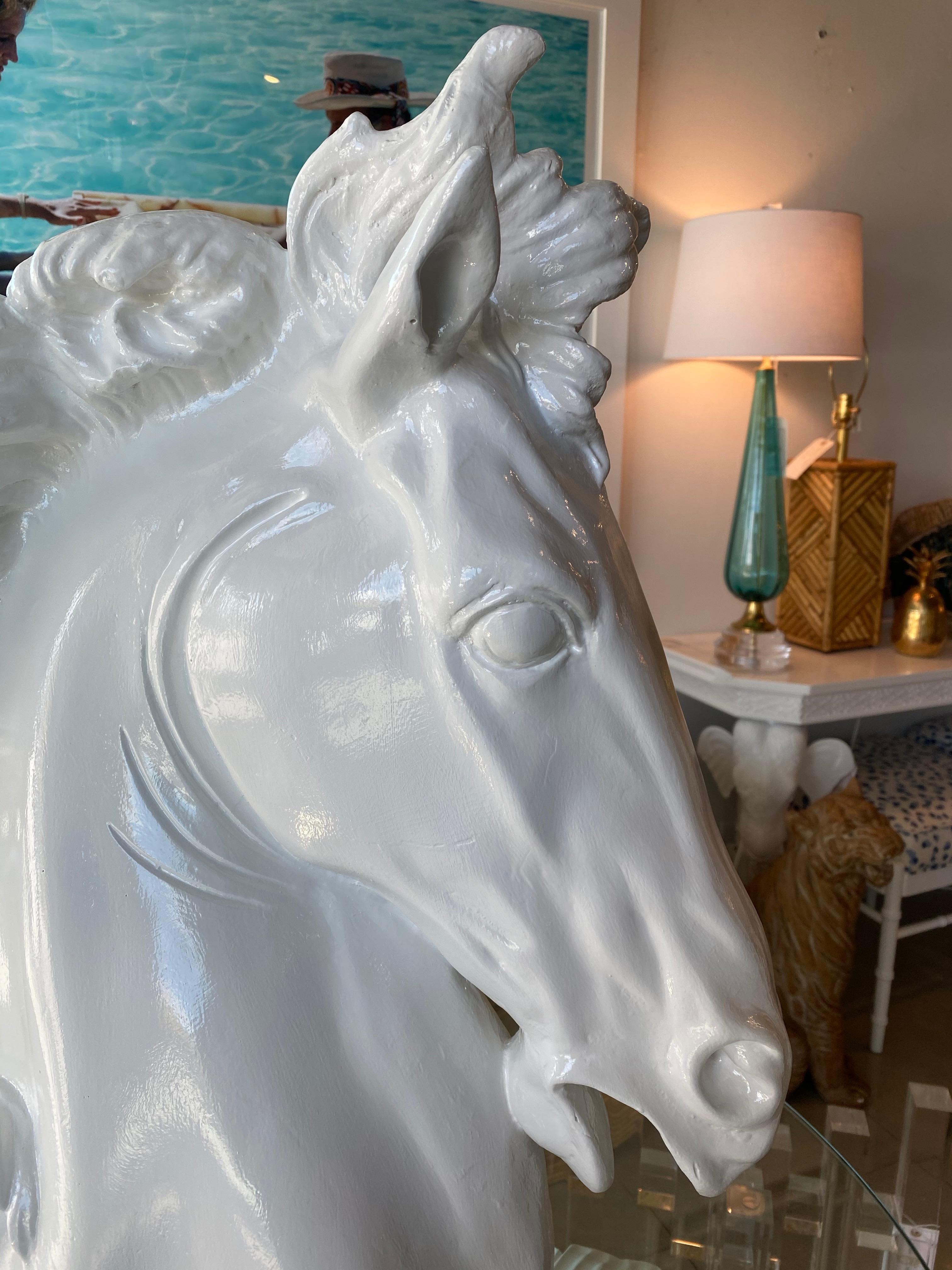 Vintage large plaster horse statue lacquered in a white gloss for a modern twist. No chips or breaks. I do have two of these listed if a pair is needed. Slight variations in plaster.