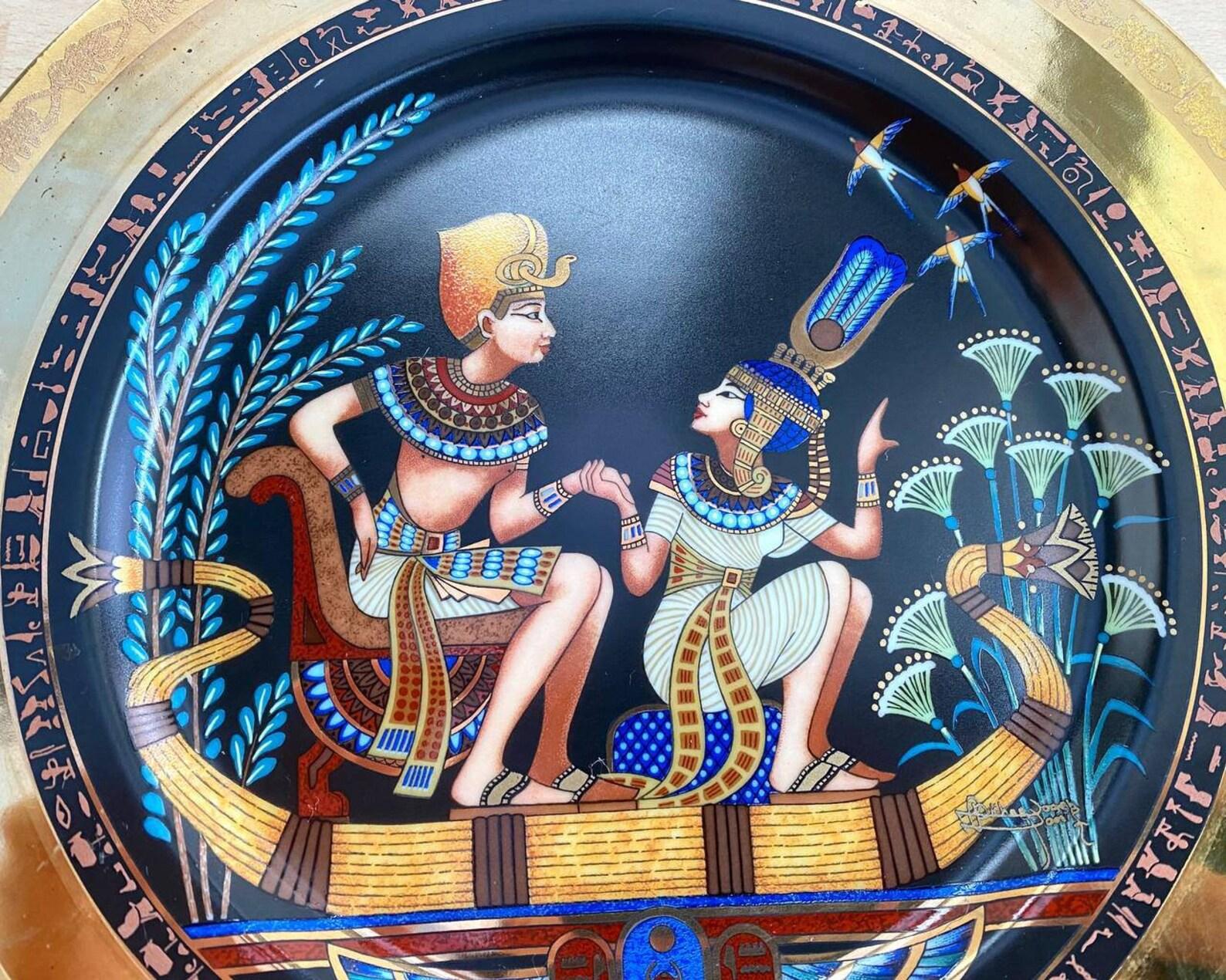 Decorative plate with an Egyptian theme.

 Porcelain vivid multicolored plate with gold rim. Luxury Plate with an ancient Egyptian scene is made by FINE ROYAL PORCELAIN SCULPTURE of Egypt.

 The plate is richly decorated with gilding. The artist