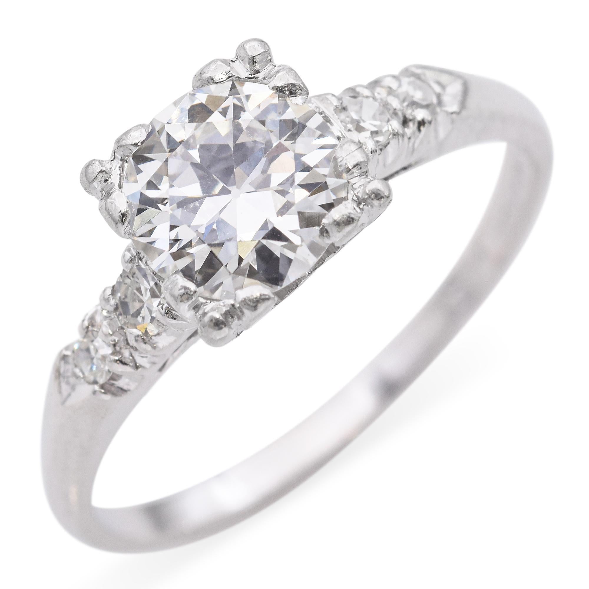 A stunning diamond engagement ring, this exquisite platinum band features a captivating 0.86-carat round cut diamond at its center, displaying a brilliant white hue that enhances its dazzling appearance. The setting is designed to allow light to