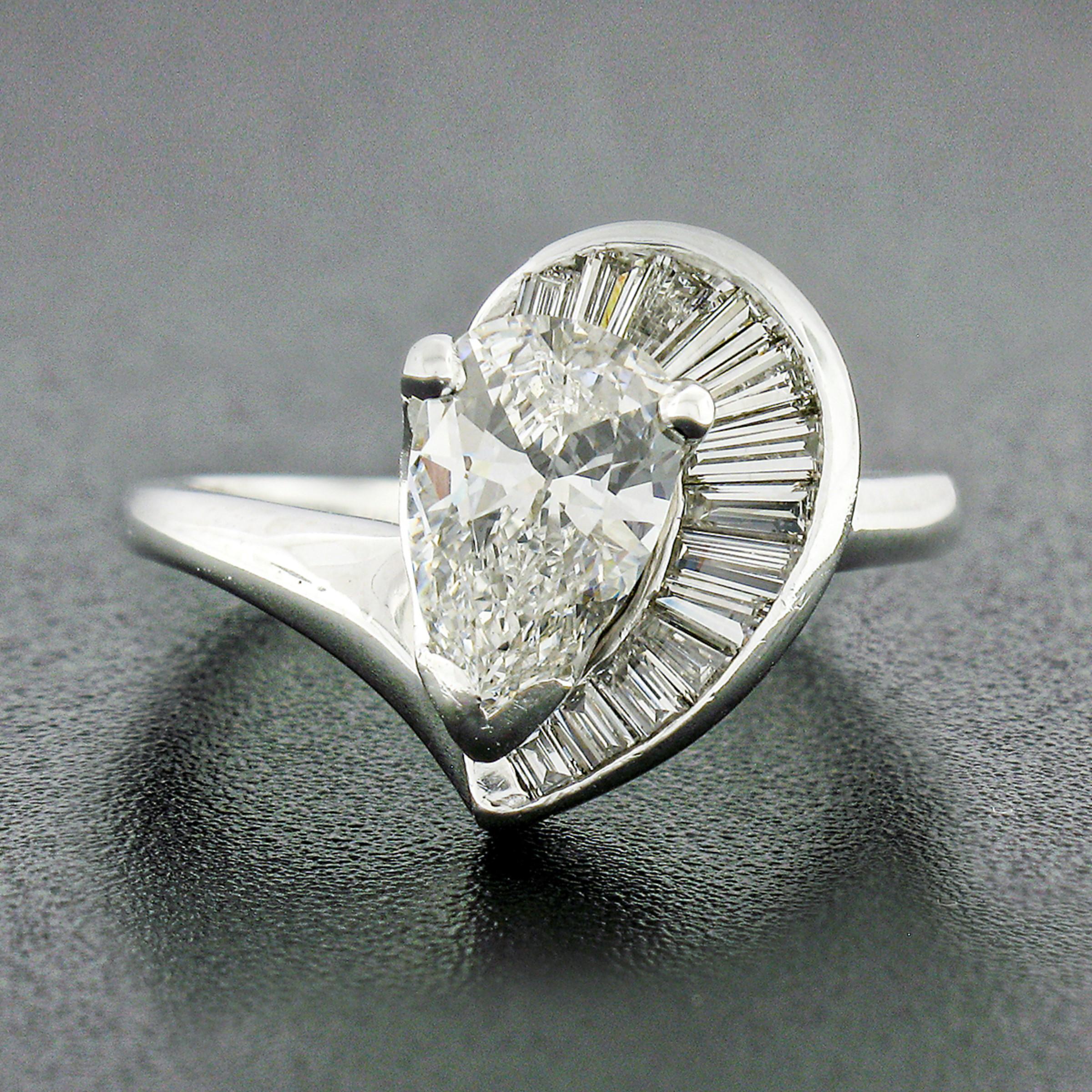 Here we have a gorgeous vintage diamond engagement ring that is crafted from solid .900 platinum featuring an exactly 1.06 carat, GIA certified, pear cut diamond solitaire neatly prong set at the center. The diamond displays amazing amount of