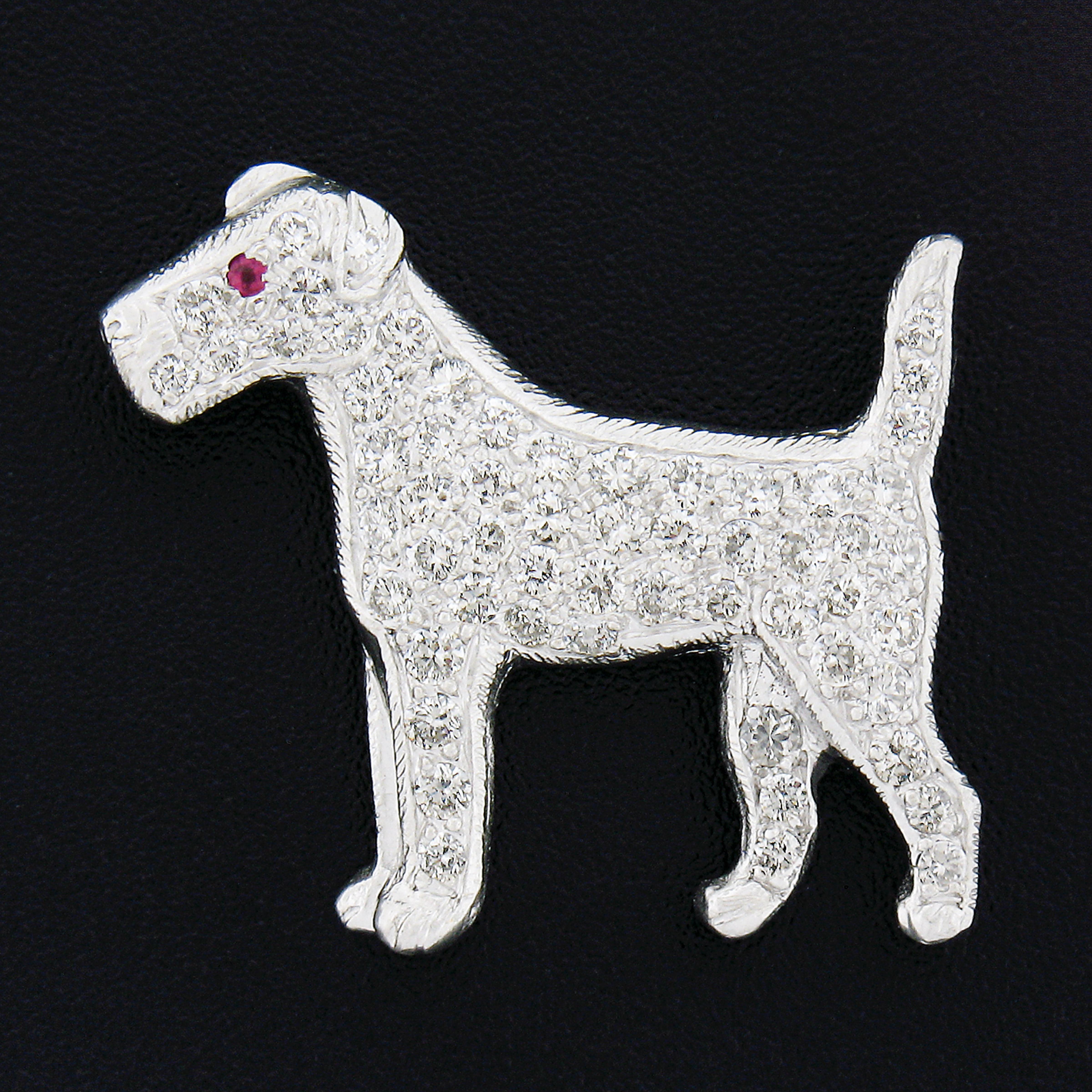 This vintage pin/brooch of an adorable Airedale dog is crafted in solid platinum and features approximately 1.25 carats of the finest quality round brilliant cut diamonds that are neatly pave set throughout its body, head, tail and legs. The