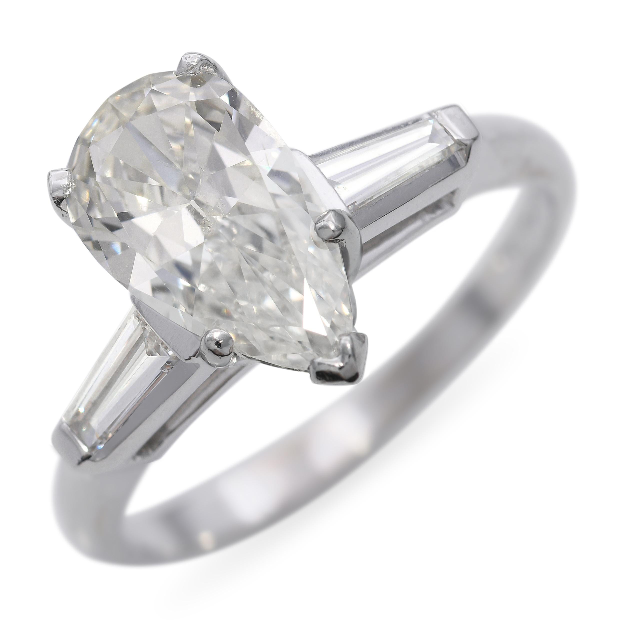 Crafted in timeless platinum, this vintage engagement ring features a stunning GIA certified 1.38ct G-color, SI2-clarity pear-shaped diamond at its center. The diamond's gentle taper and brilliant faceting offer both elegance and sparkle,