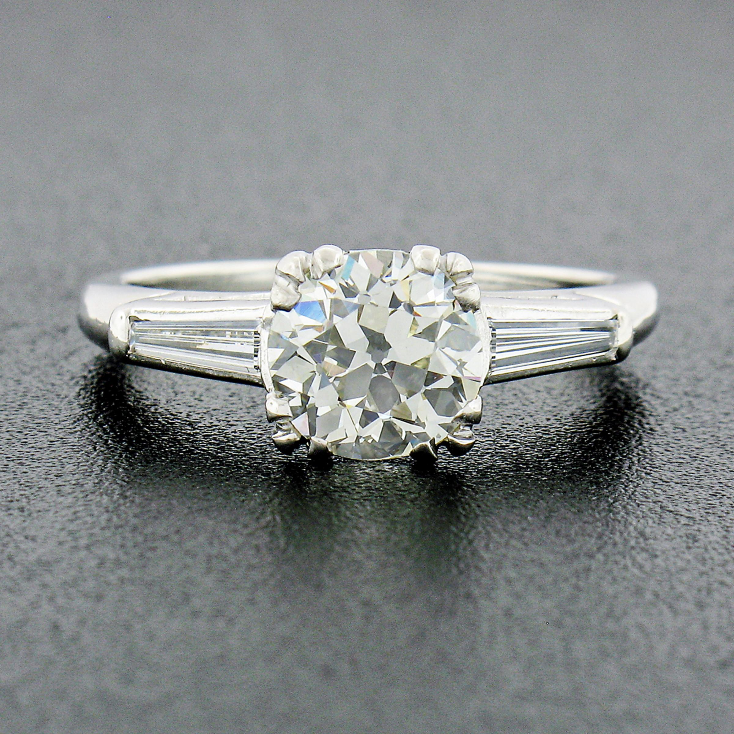 This breathtaking vintage diamond engagement ring was crafted from solid platinum and features a gorgeous, old European cut, diamond solitaire at its center. The diamond is GIA certified, weighing exactly 1.40 carats, showing a nice large size and