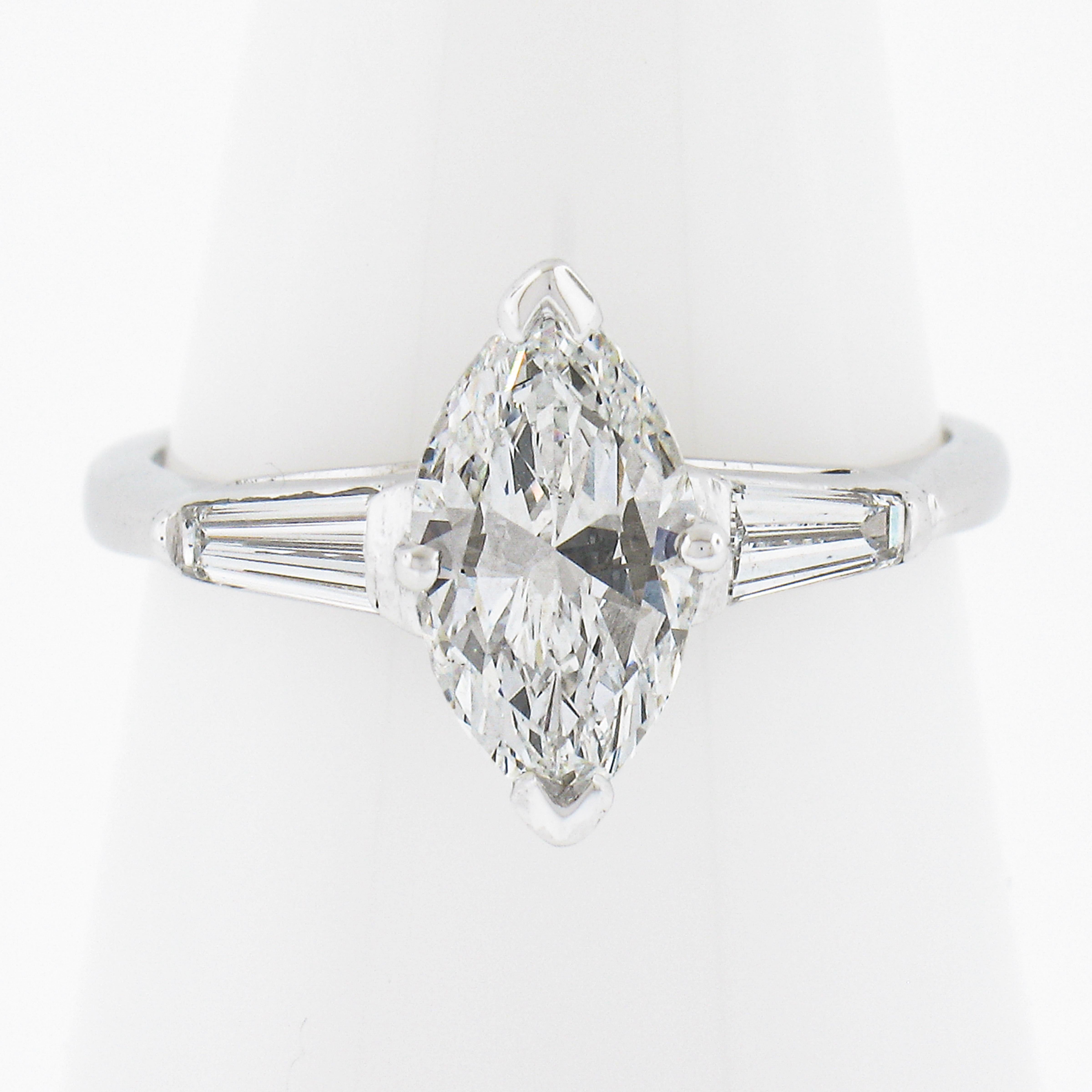 --Stone(s):--
(1) Natural Genuine Diamond - Marquise Cut - Prong Set - F Color - VS2 Clarity - 1.32ct (exact - certified)
** See Certification Details Below for Complete Info **
(2) Natural Genuine Diamonds - Tapered Baguette Cut - Channel Set - F/G