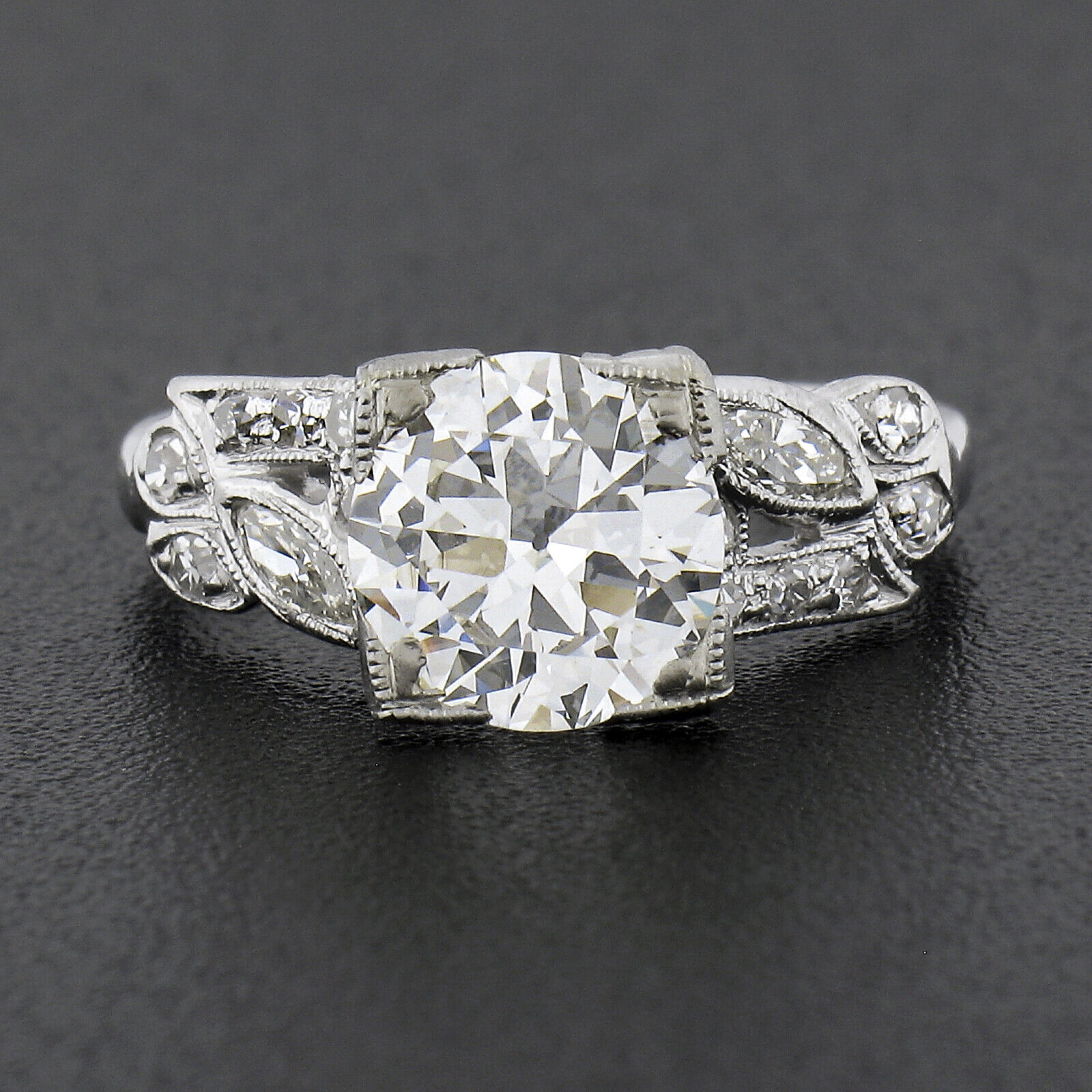 This breathtaking vintage diamond engagement ring was crafted during the 1940's from solid platinum. It features a fine quality, GIA certified, old European cut diamond solitaire neatly set with squared prongs at its center, and is stated to be