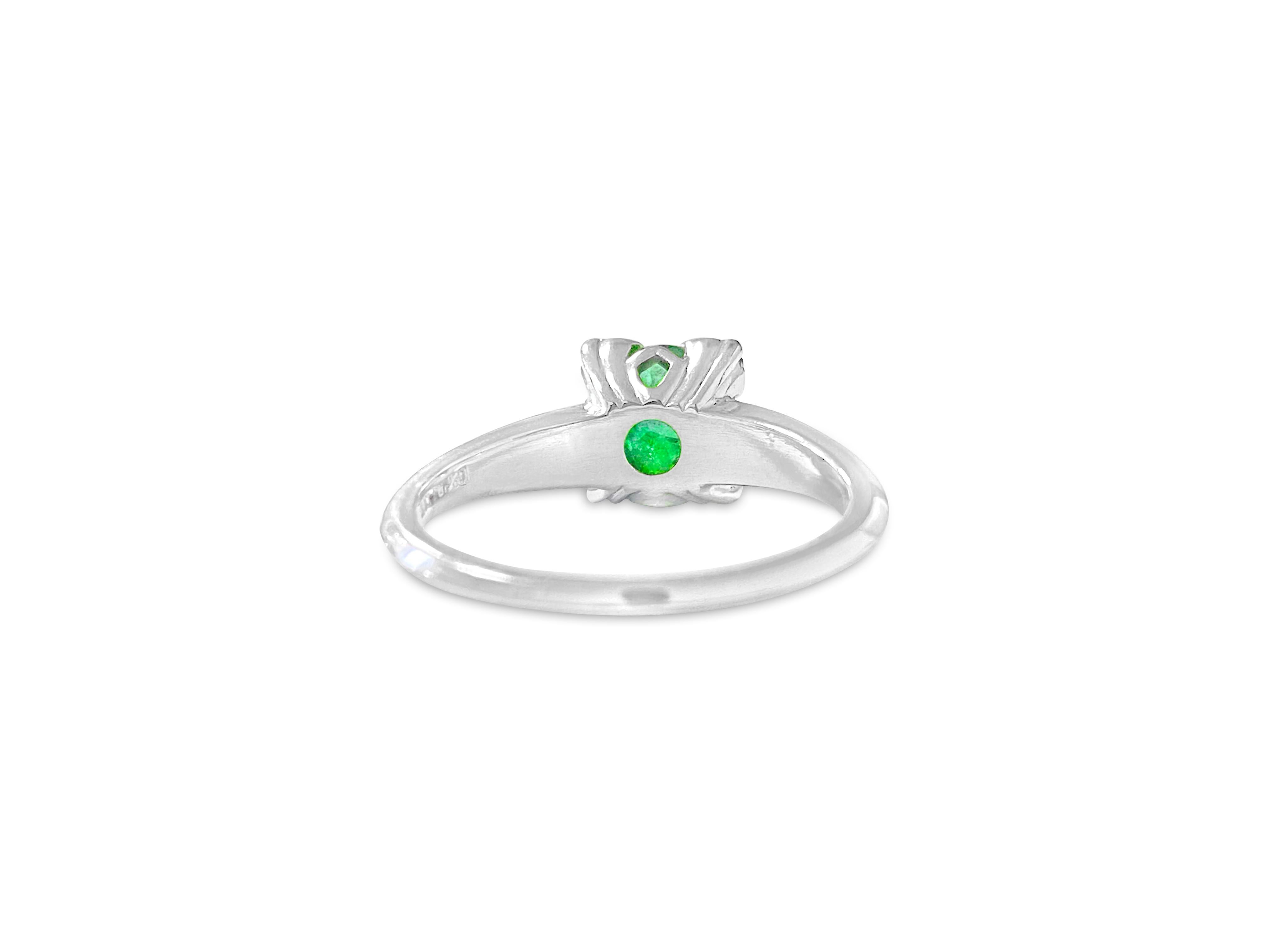 Fashioned from lustrous platinum, this captivating ring boasts a dazzling 1.70 carat emerald alongside a 0.06 carat fancy green diamond. An ideal choice for a stunning engagement ring.

Key Features:

Metal: Platinum.
1.70 carat emerald.
0.06 carat