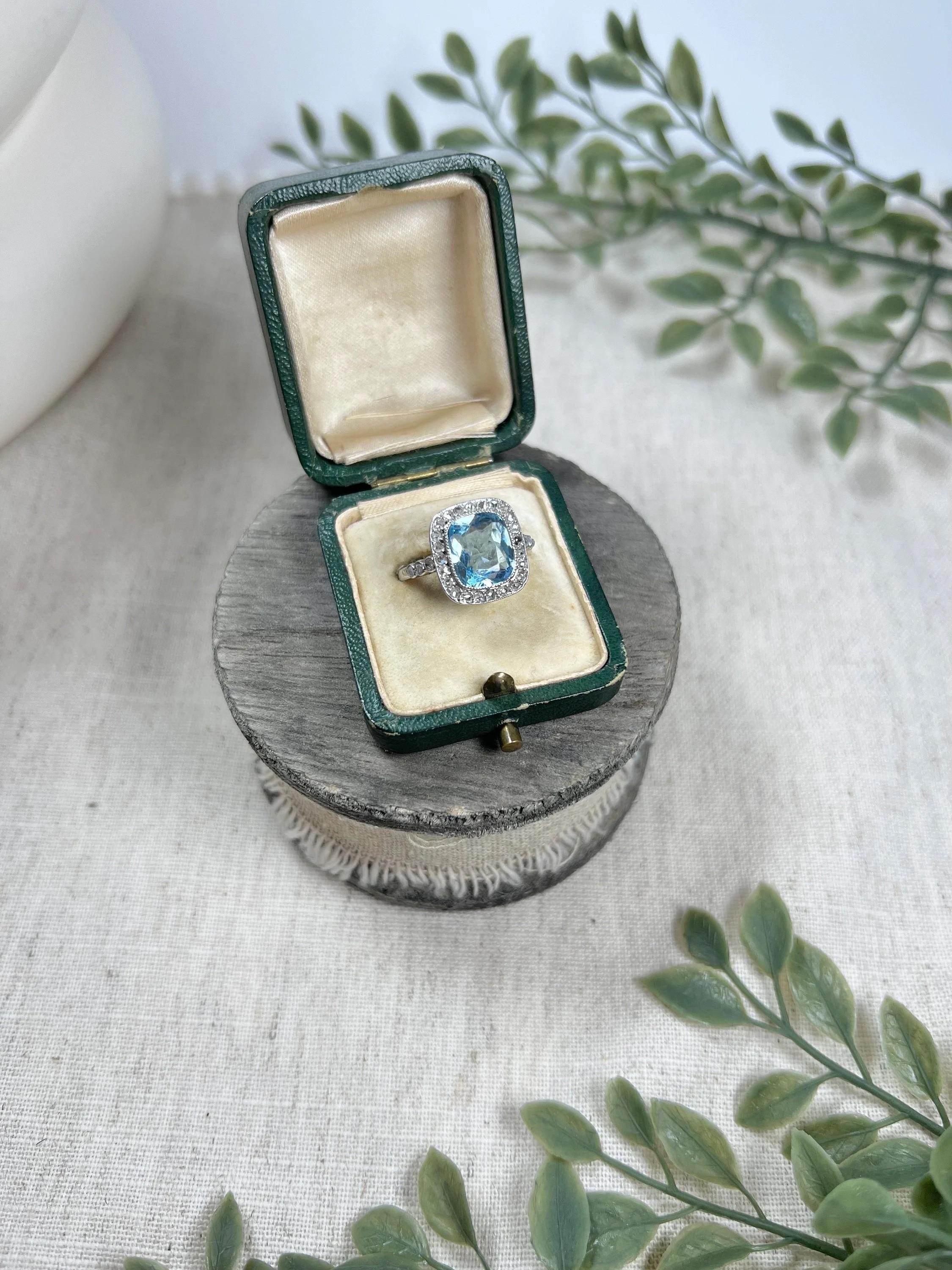 Vintage Aquamarine Ring 

Platinum Tested

Circa 1940’s

Fabulous, vintage ring. Set with a gorgeous, faceted-cushion cut, natural aquamarine. Mounted in platinum, with a beautiful halo of sparkling, natural, rose cut diamonds. Complimented