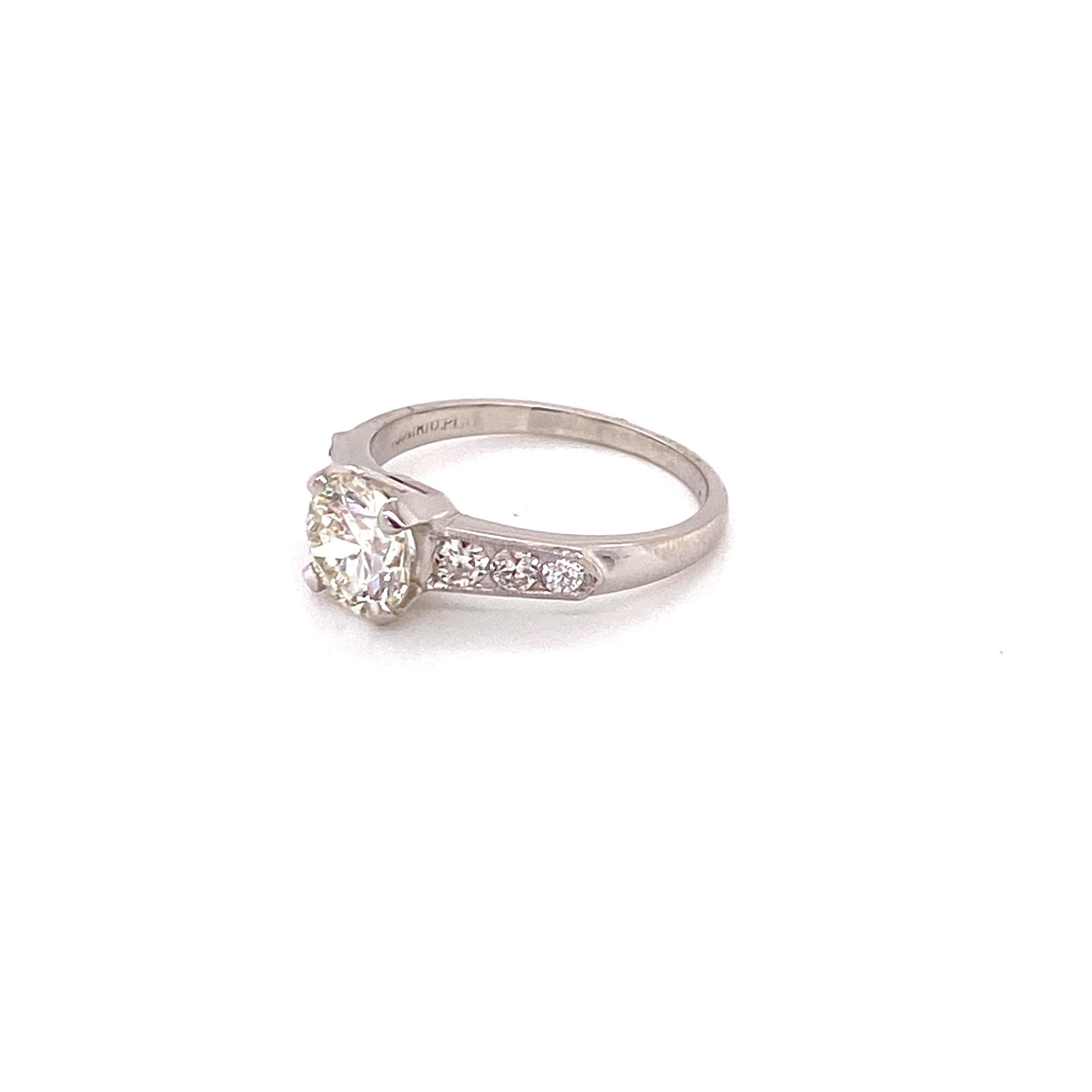 Vintage Platinum 1950s 1.31ct Round Diamond Ring - Center circular brilliant transitional cut diamonds weighs 1.31ct and has K color, and SI1 clarity. Channel set on either side with a milgrain border are 3 round diamonds with a total approximate