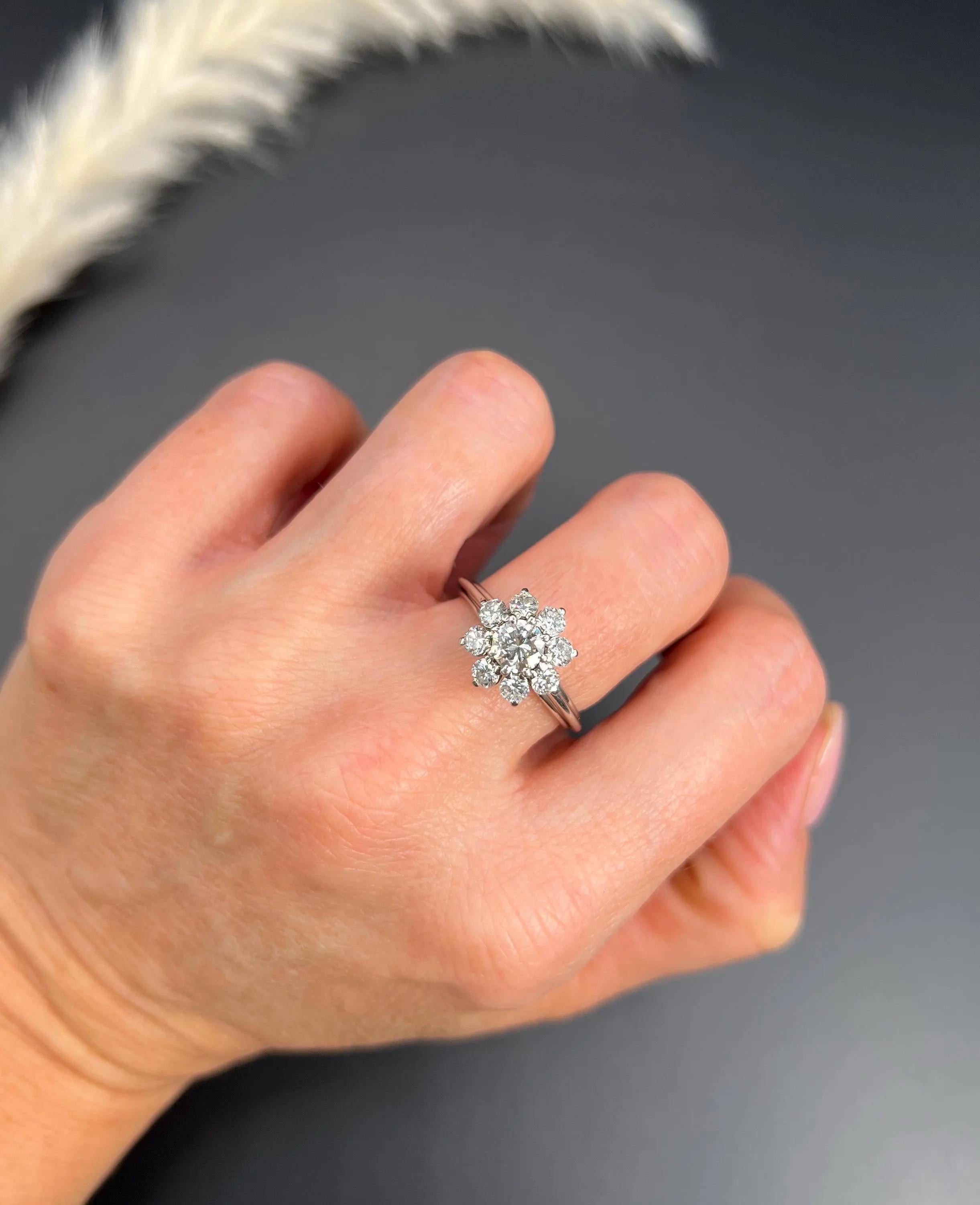 Vintage Diamond Daisy Ring 

Platinum Tested

Step into the elegance of the past with this exquisite vintage 1980s platinum daisy ring. This stunning piece features approximately 1.50 carats of natural, dazzling diamonds, artfully arranged in a